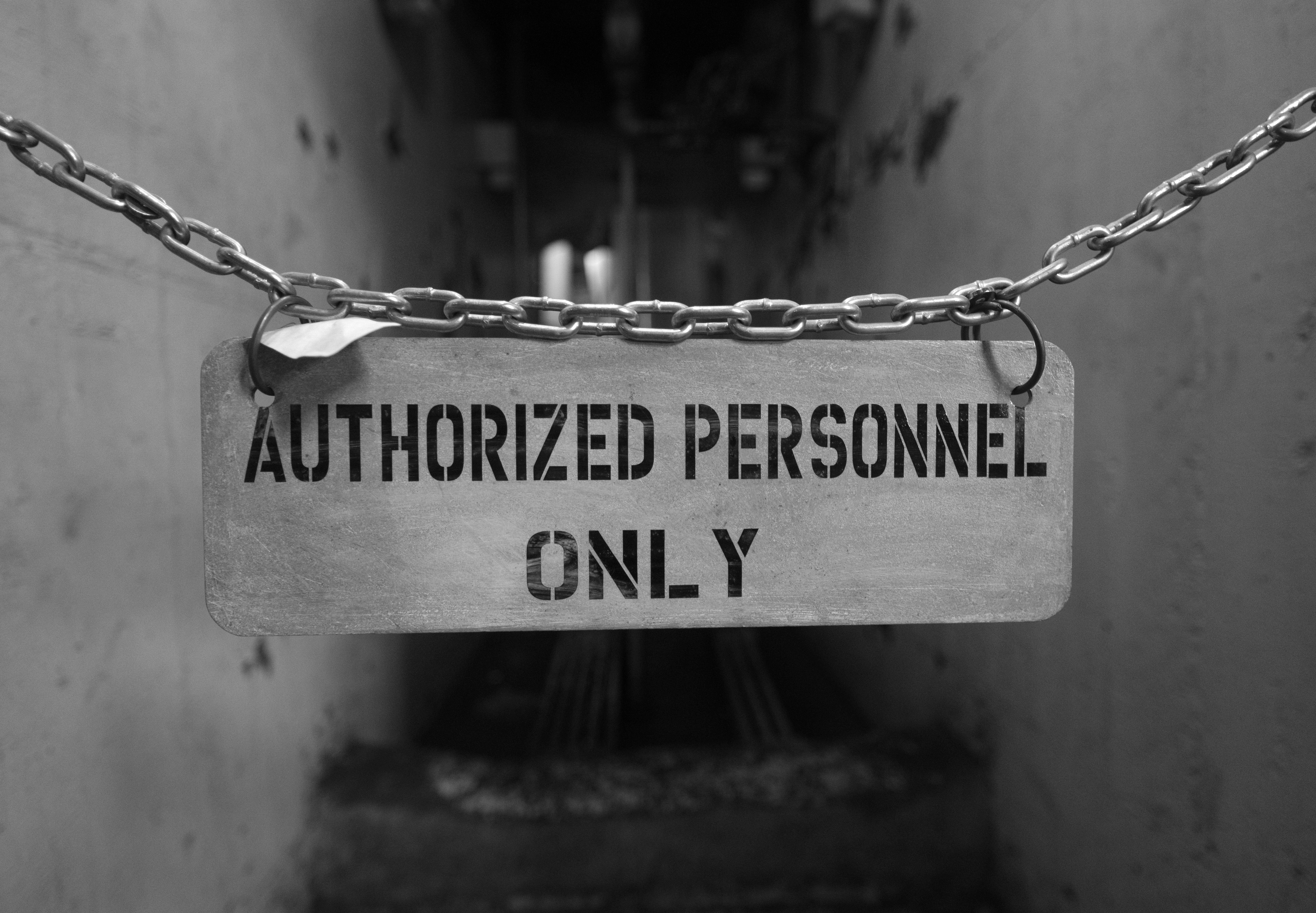 Authorized personnel only sign hanging on chains