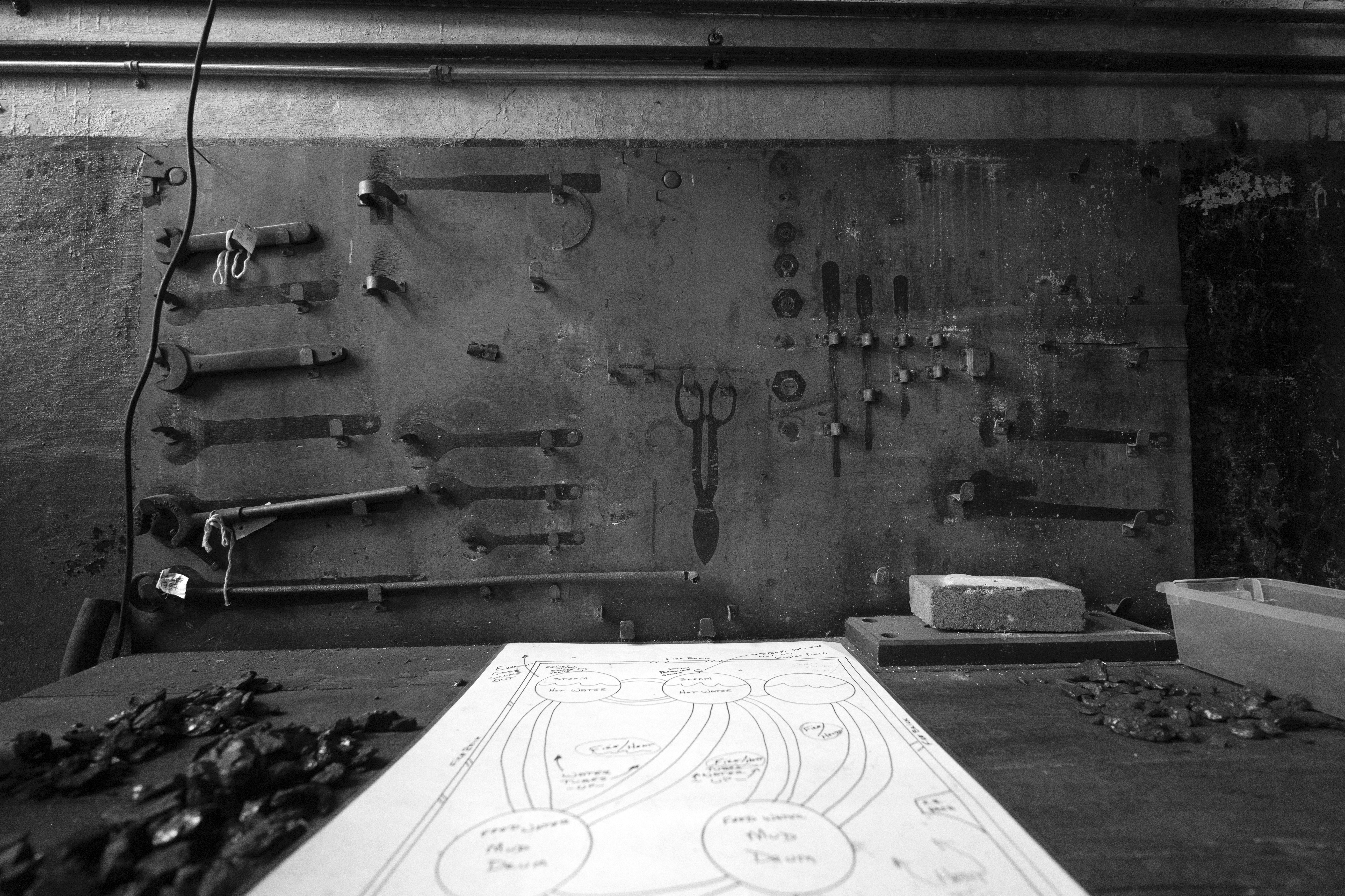 Tools arranged on a wall above a workbench