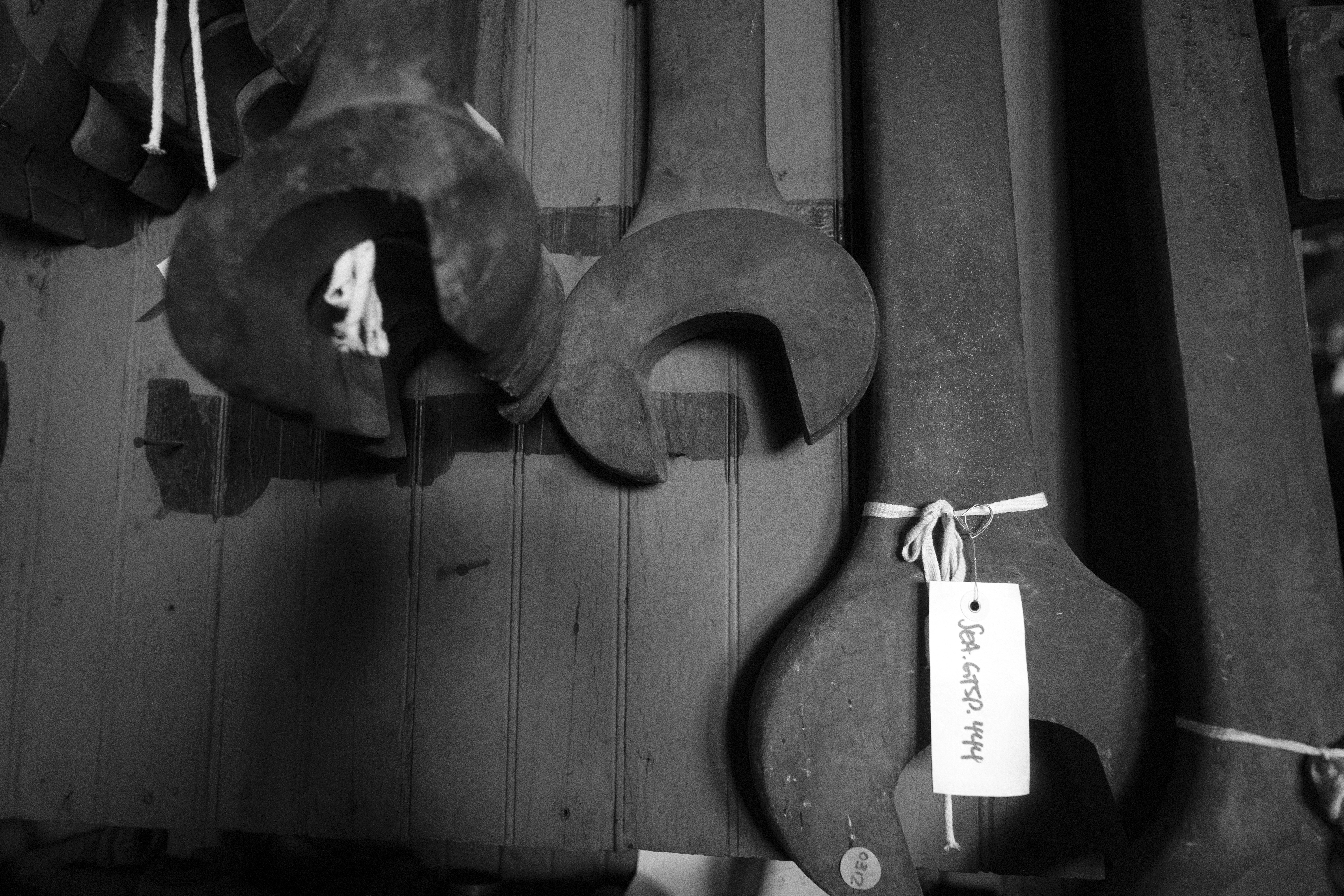 Three large wrenches hanging on a wall