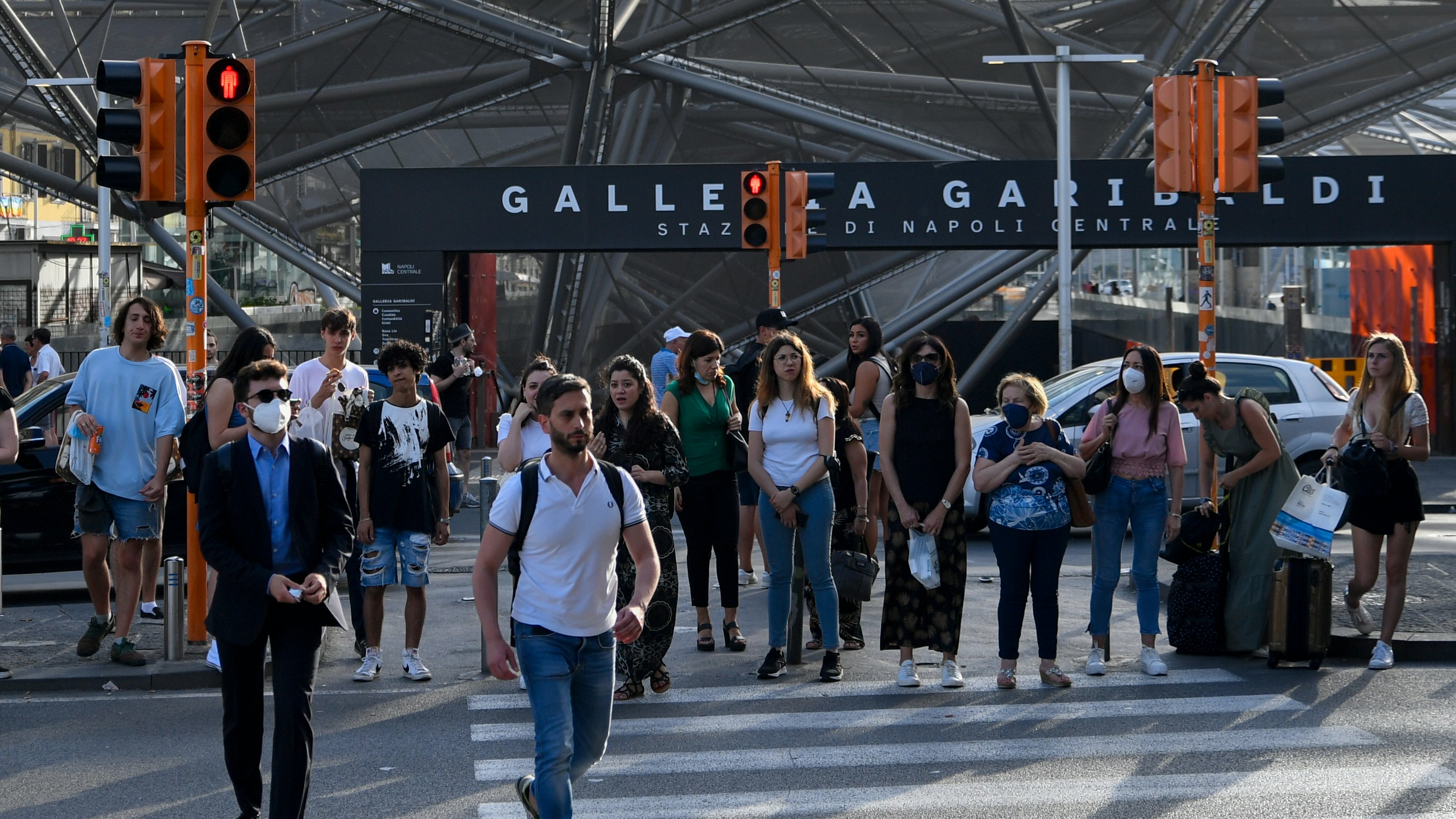 Pedestrians walking near Piazza Garibaldi central railway station in Naples, Italy.