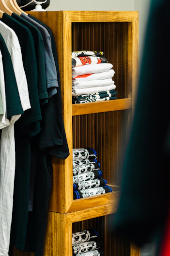 Stack of folded clothes on wooden shelves