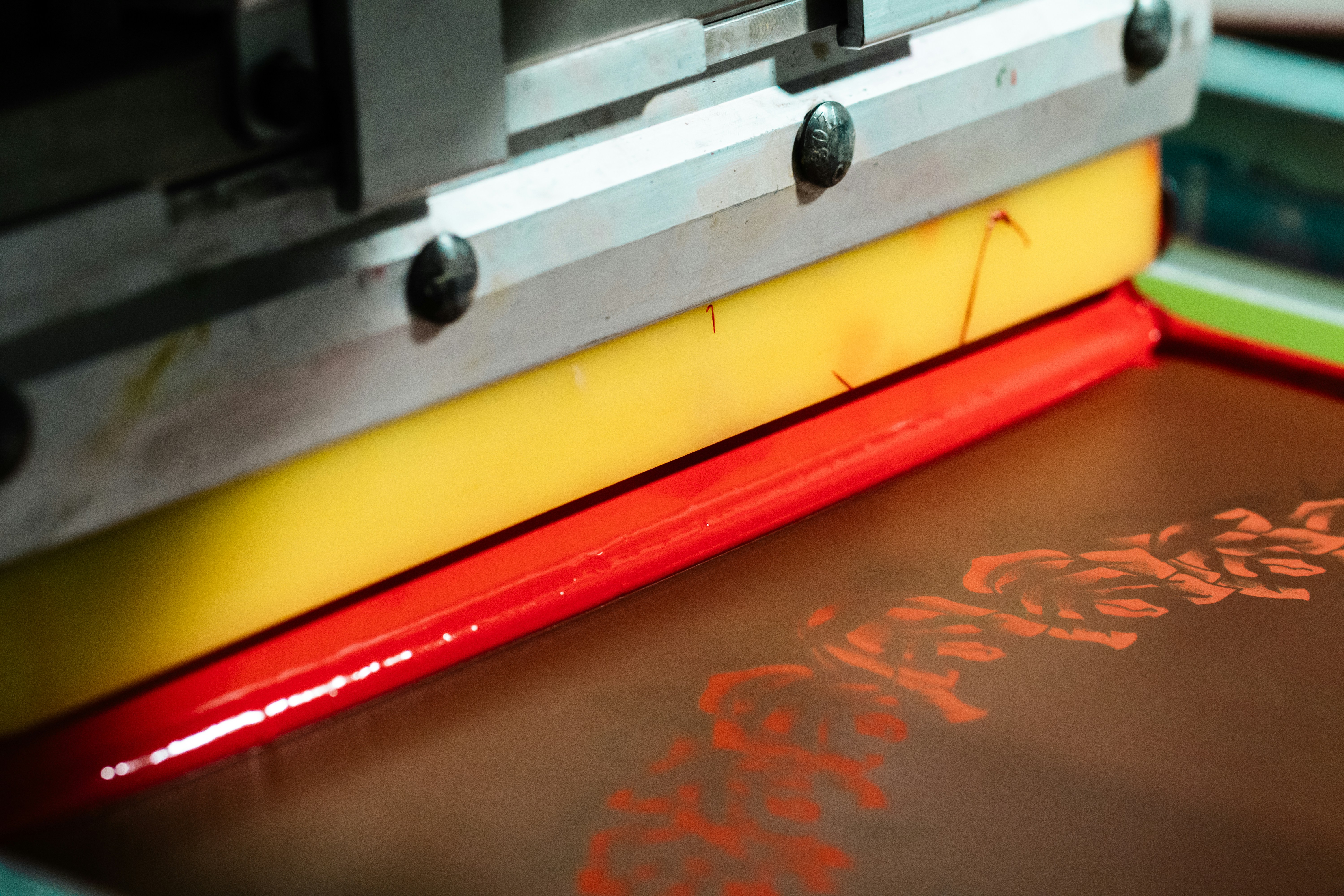 Close-up of screen printing with red ink.