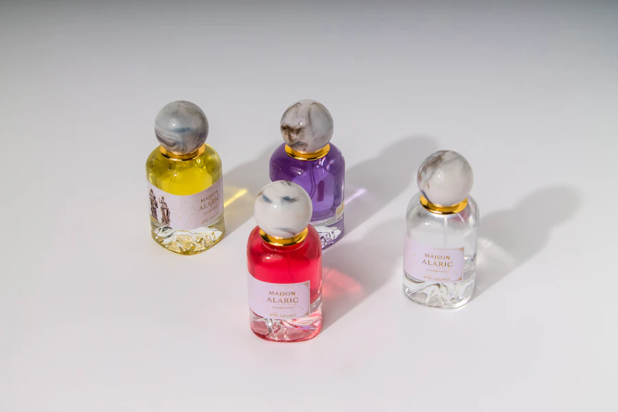 Four colorful perfume bottles arranged on a white surface.
