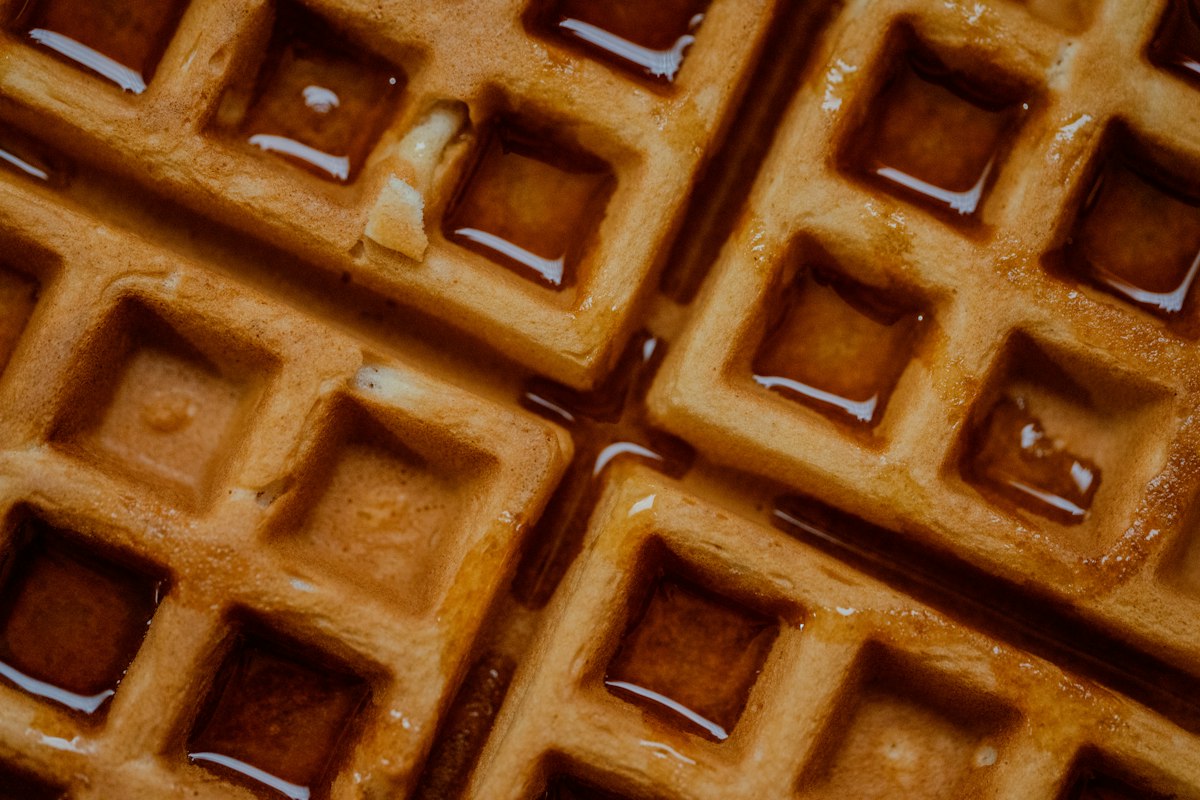 Golden square waffles with syrup - choosing between mini and Belgian waffle makers