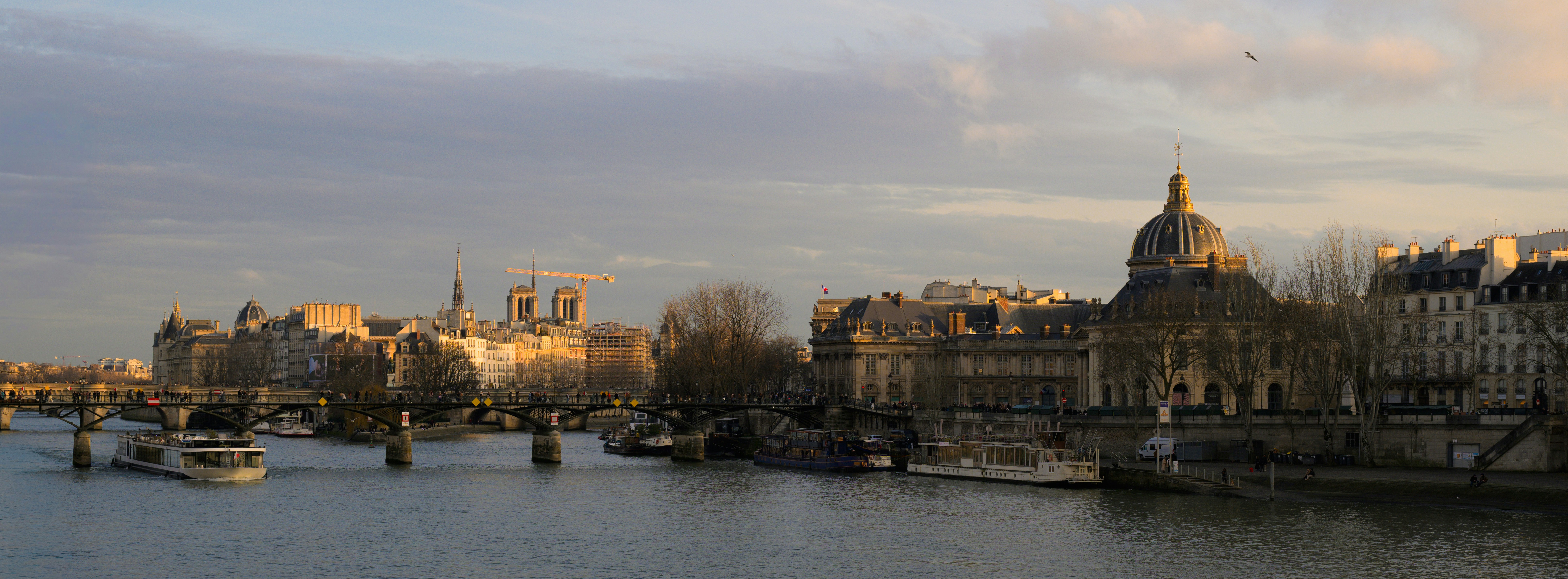 River with buildings and dome at sunset