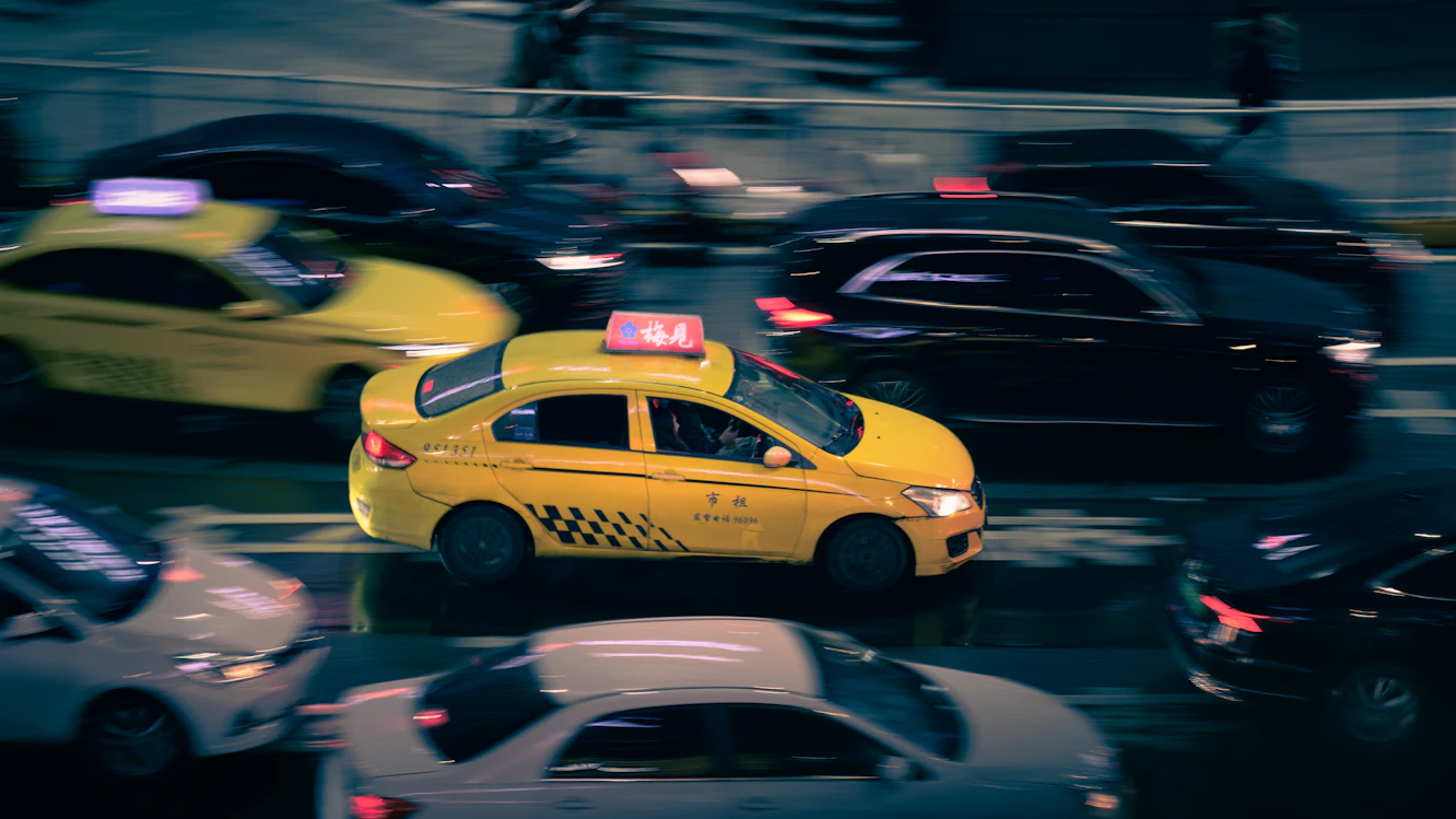Real yellow taxi in city traffic in Chongqing China