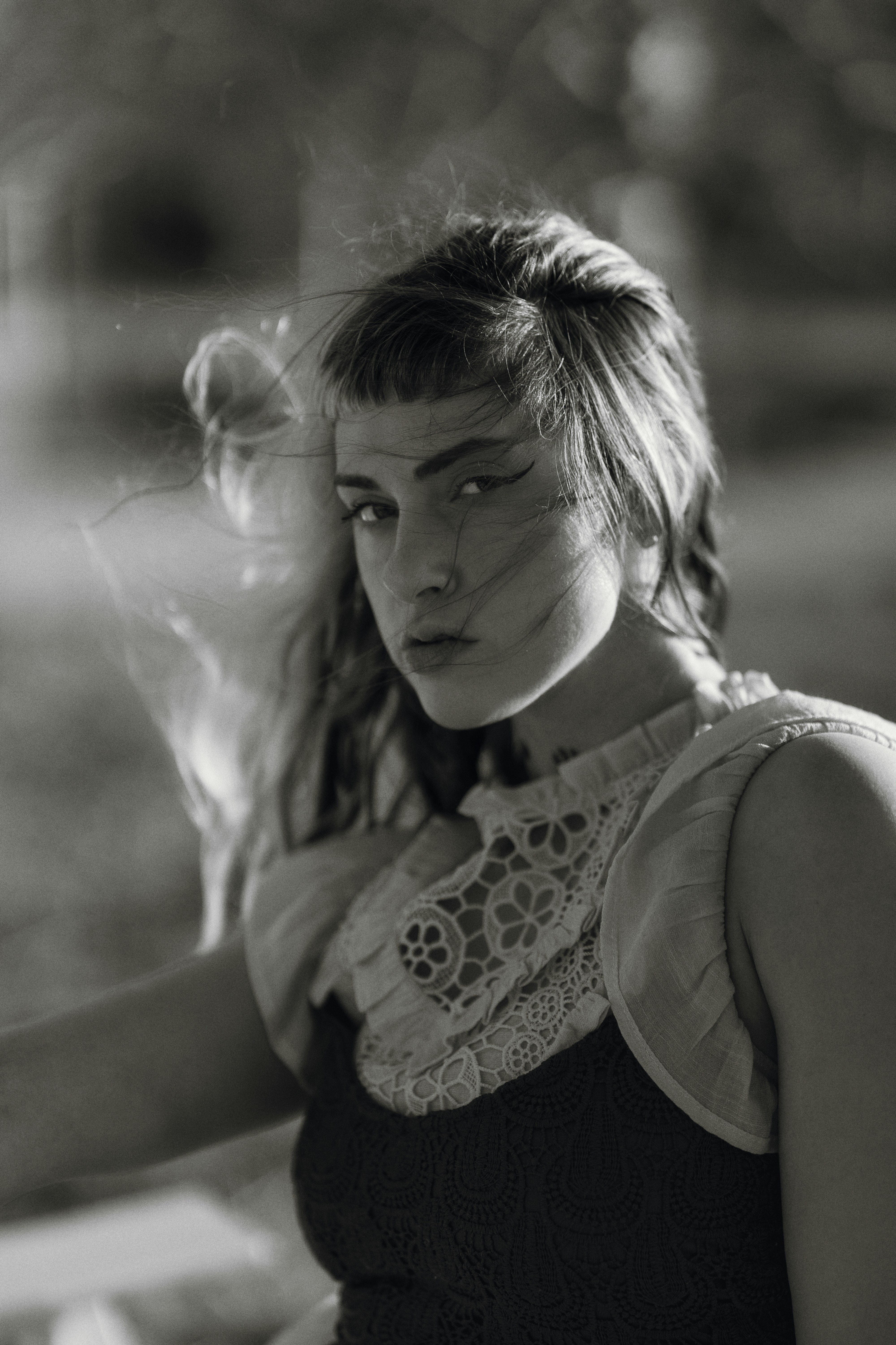 Young woman with windswept hair looks at camera