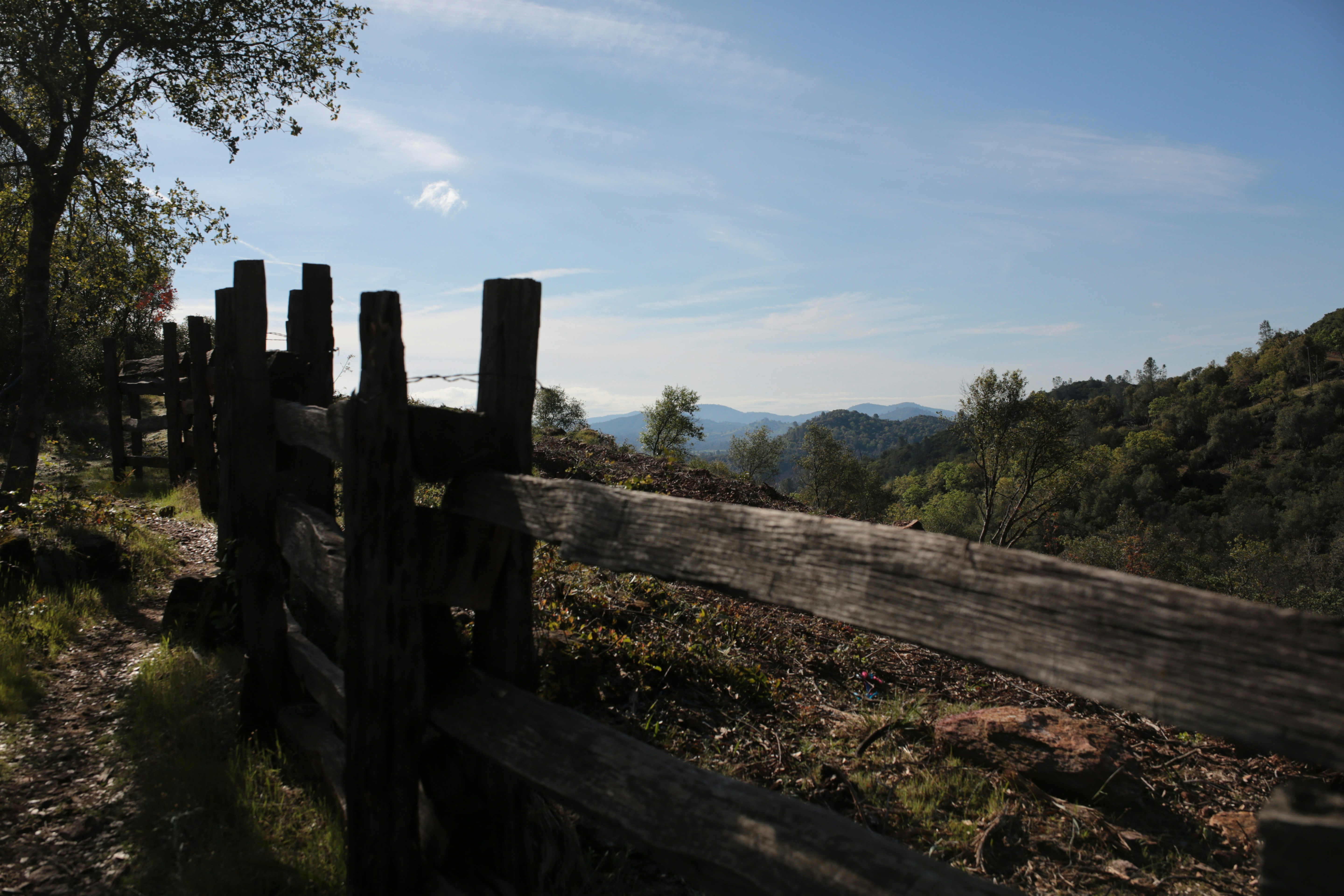 Wooden fence along a scenic mountain trail