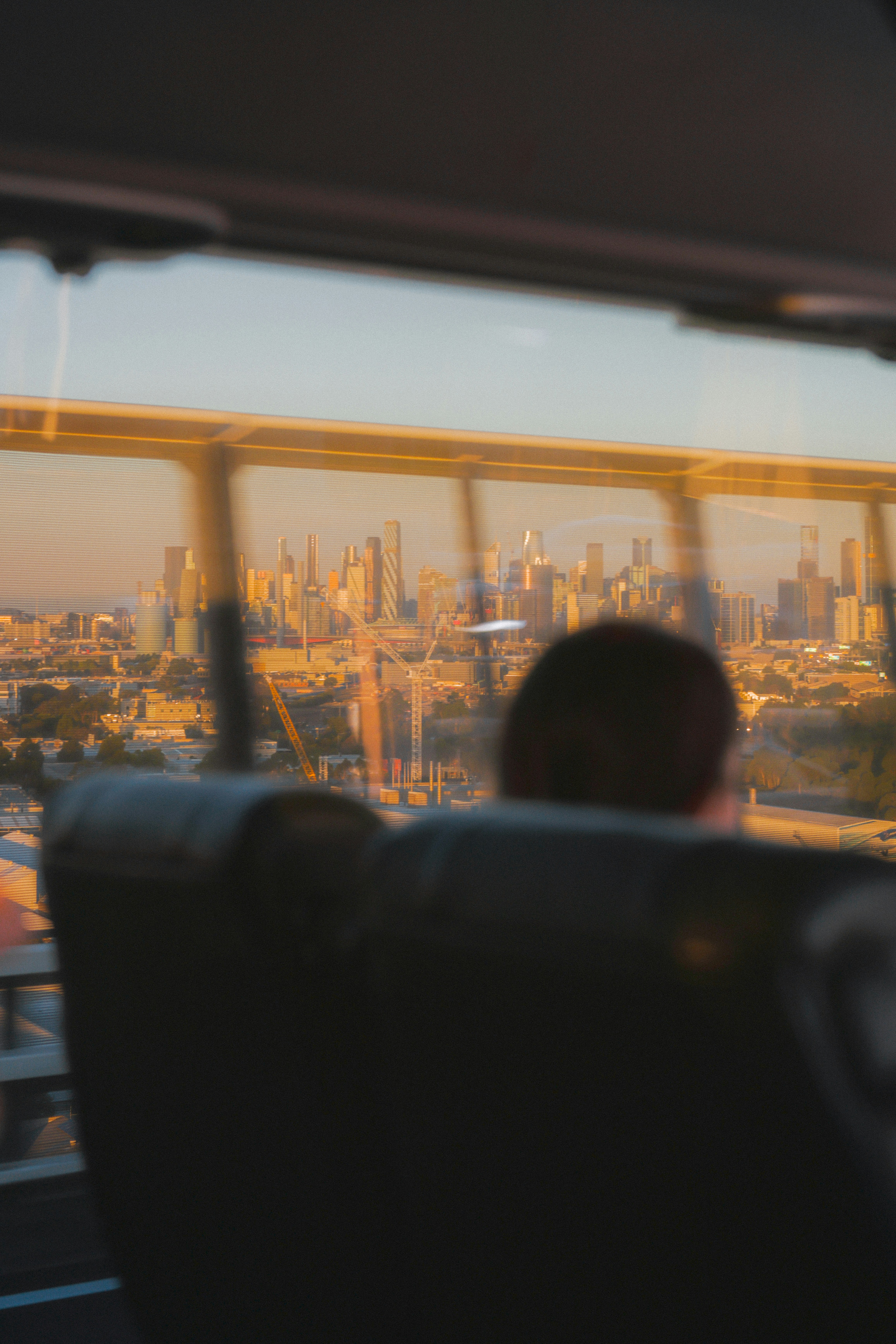 Person looking at cityscape through bus window