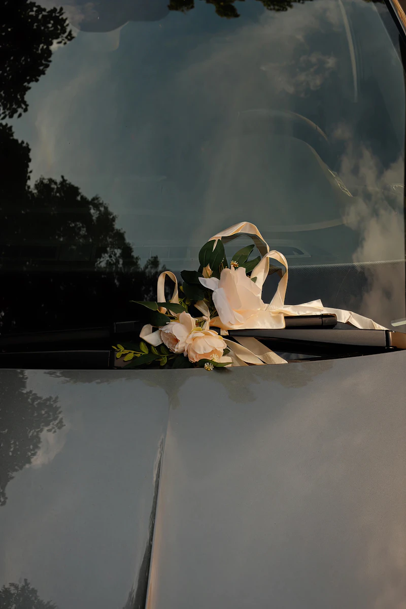 Wedding car decorated with flowers and ribbon