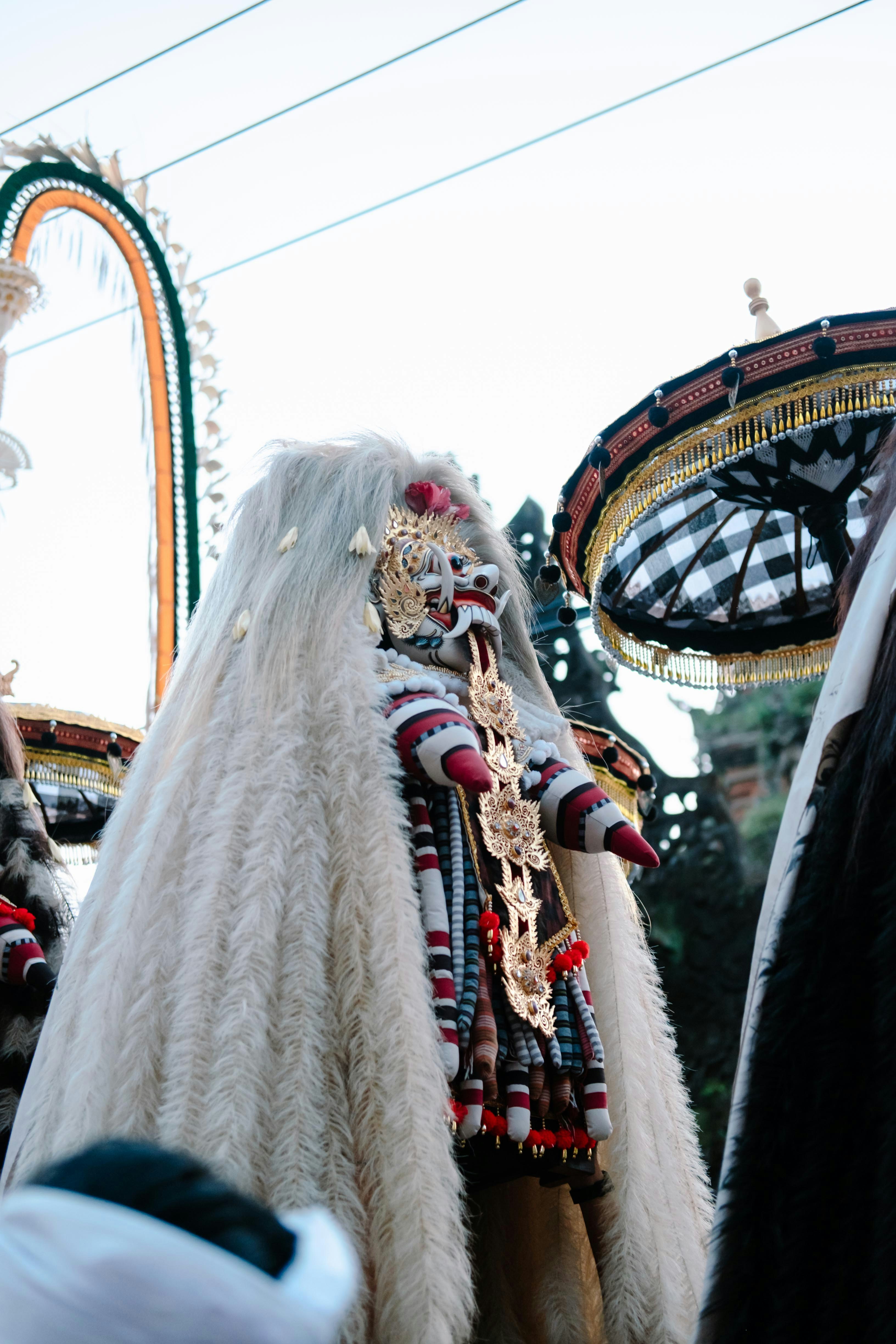 A person in a white furry costume with a mask.