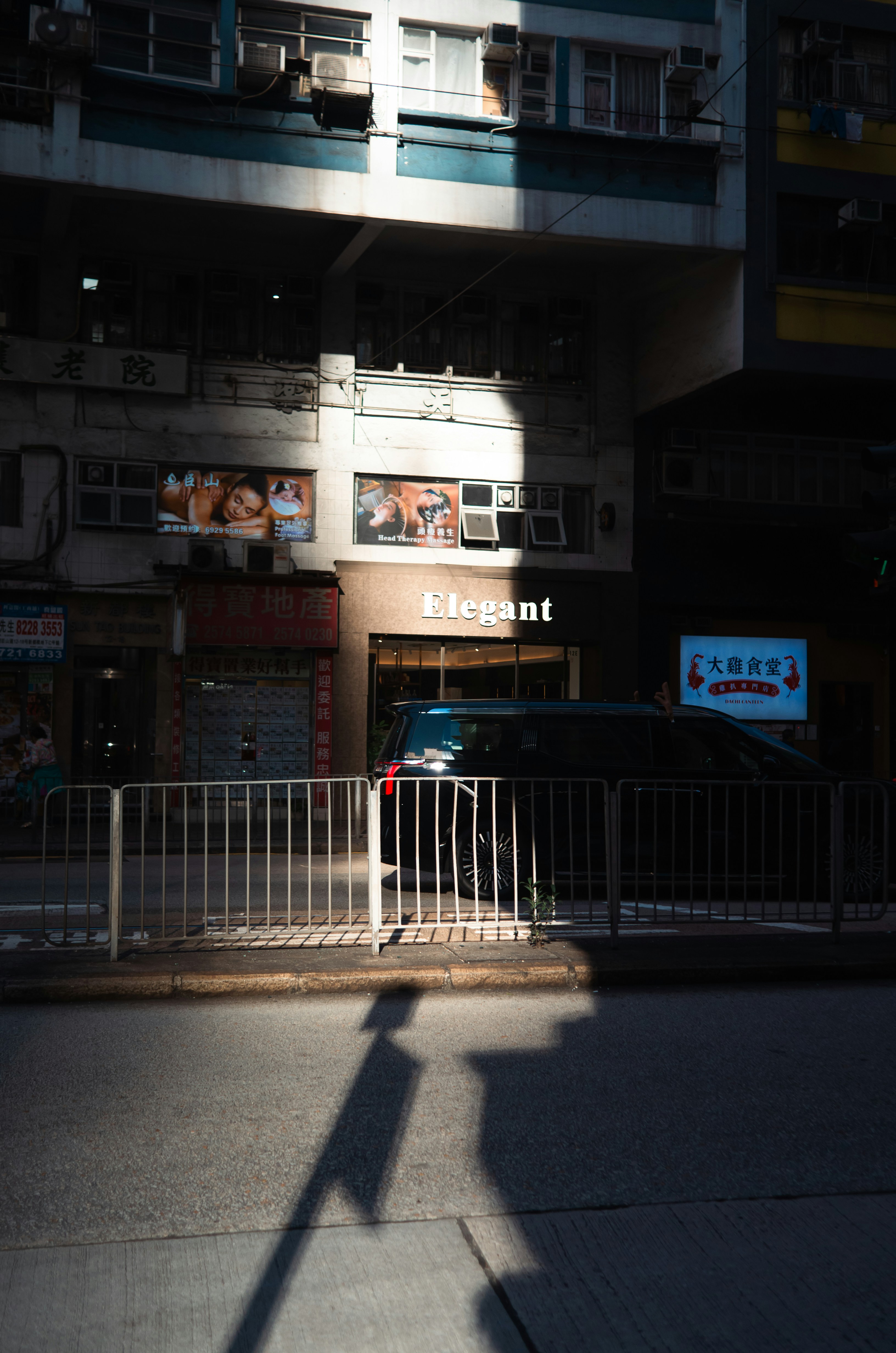 Sunlight and shadow on a city street with buildings. - 相关推荐