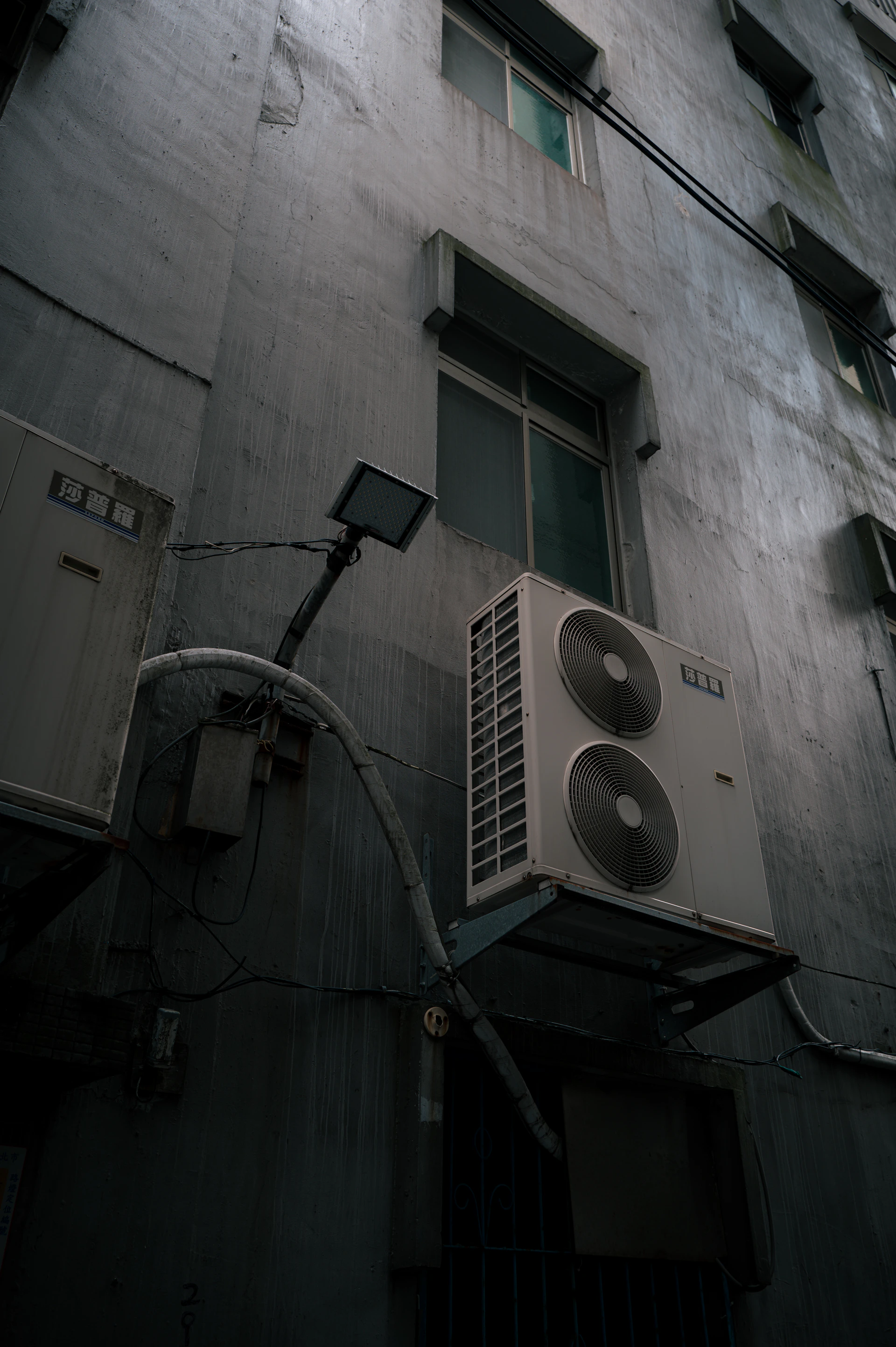 Exterior wall with air conditioning units and windows
