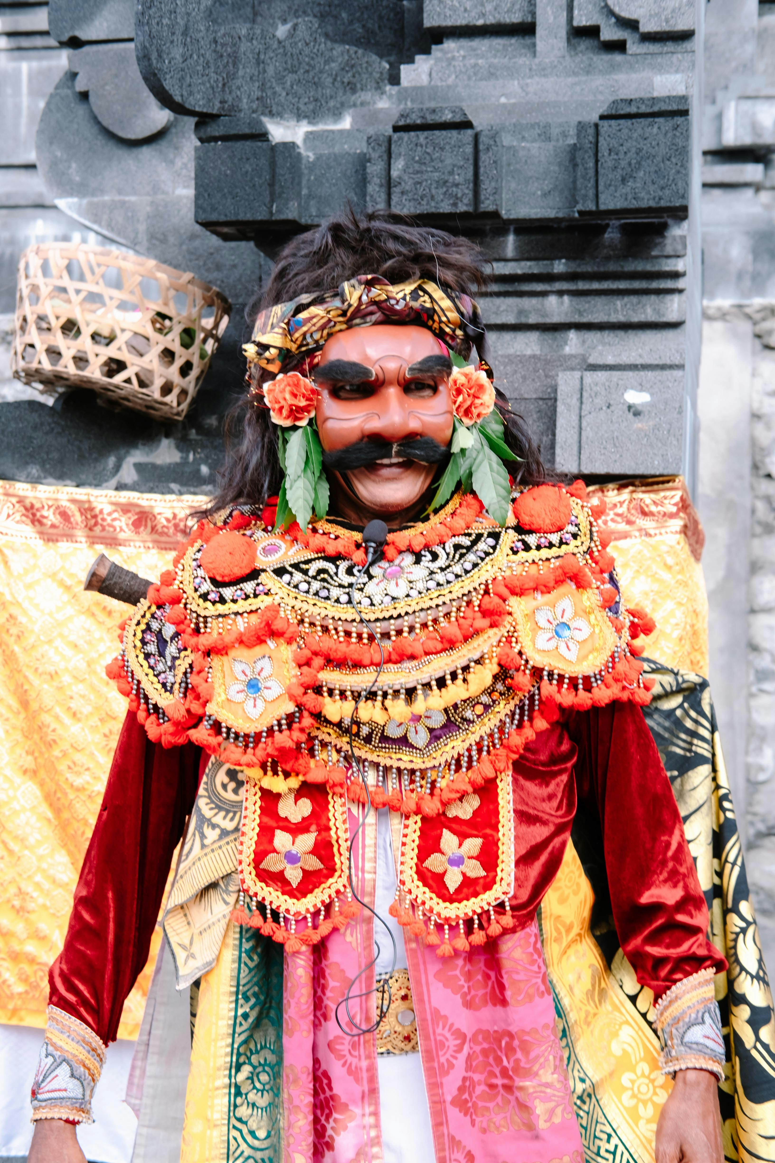 Man in elaborate traditional costume and mask