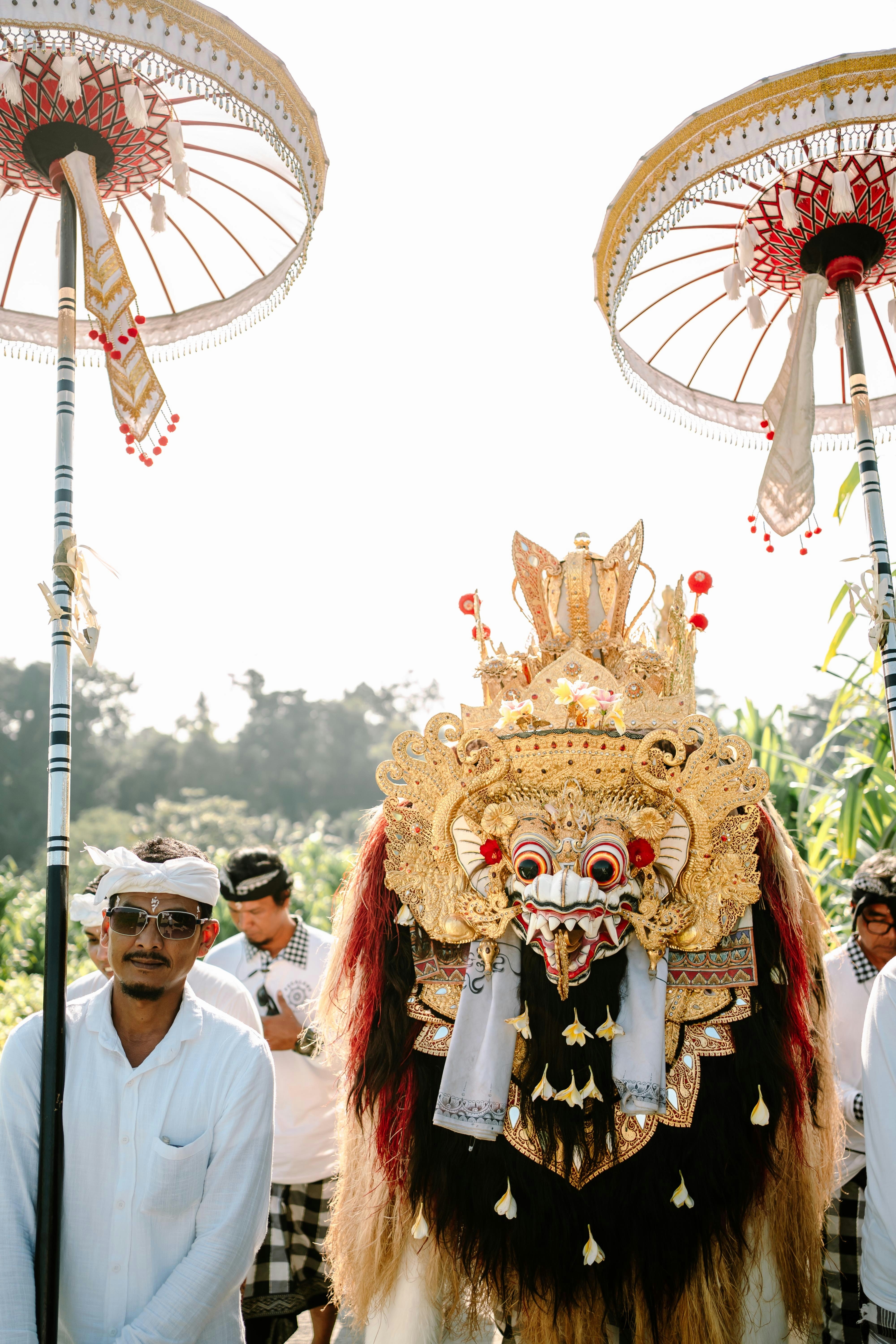 A traditional balinese barong mask and dancers