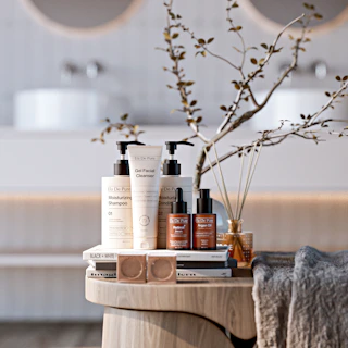 Skincare products arranged on a wooden table.