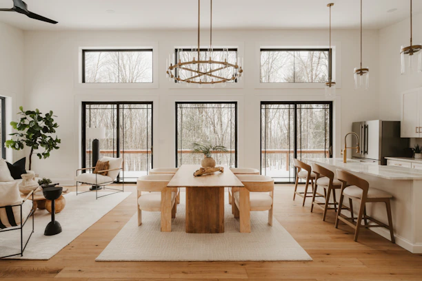 Modern dining and living area with large windows