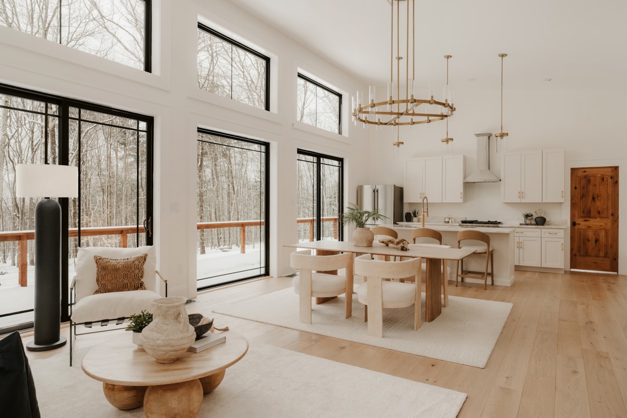 Open-concept luxury living room in Granite Bay with double-height ceilings, marble accent wall, and floor-to-ceiling windows — Granite Bay real estate 2026