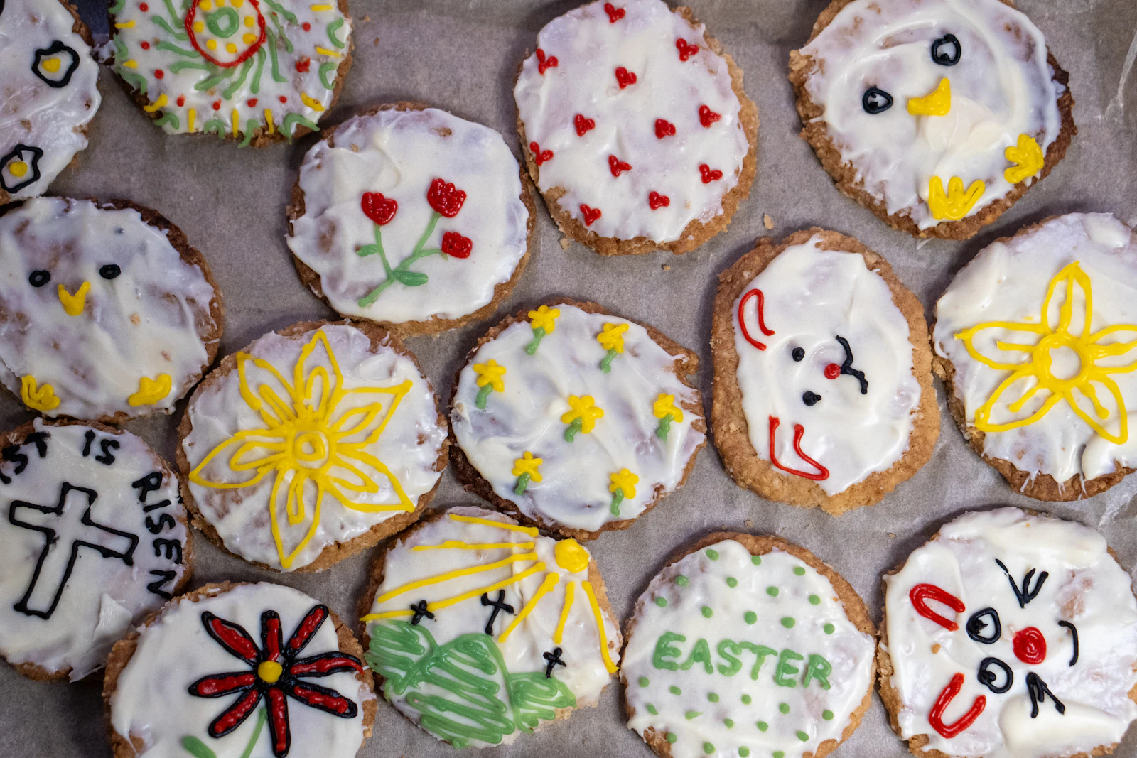 A set of individually decorated custom cookies with varied festive designs, the kind used as party favors or a themed gift set