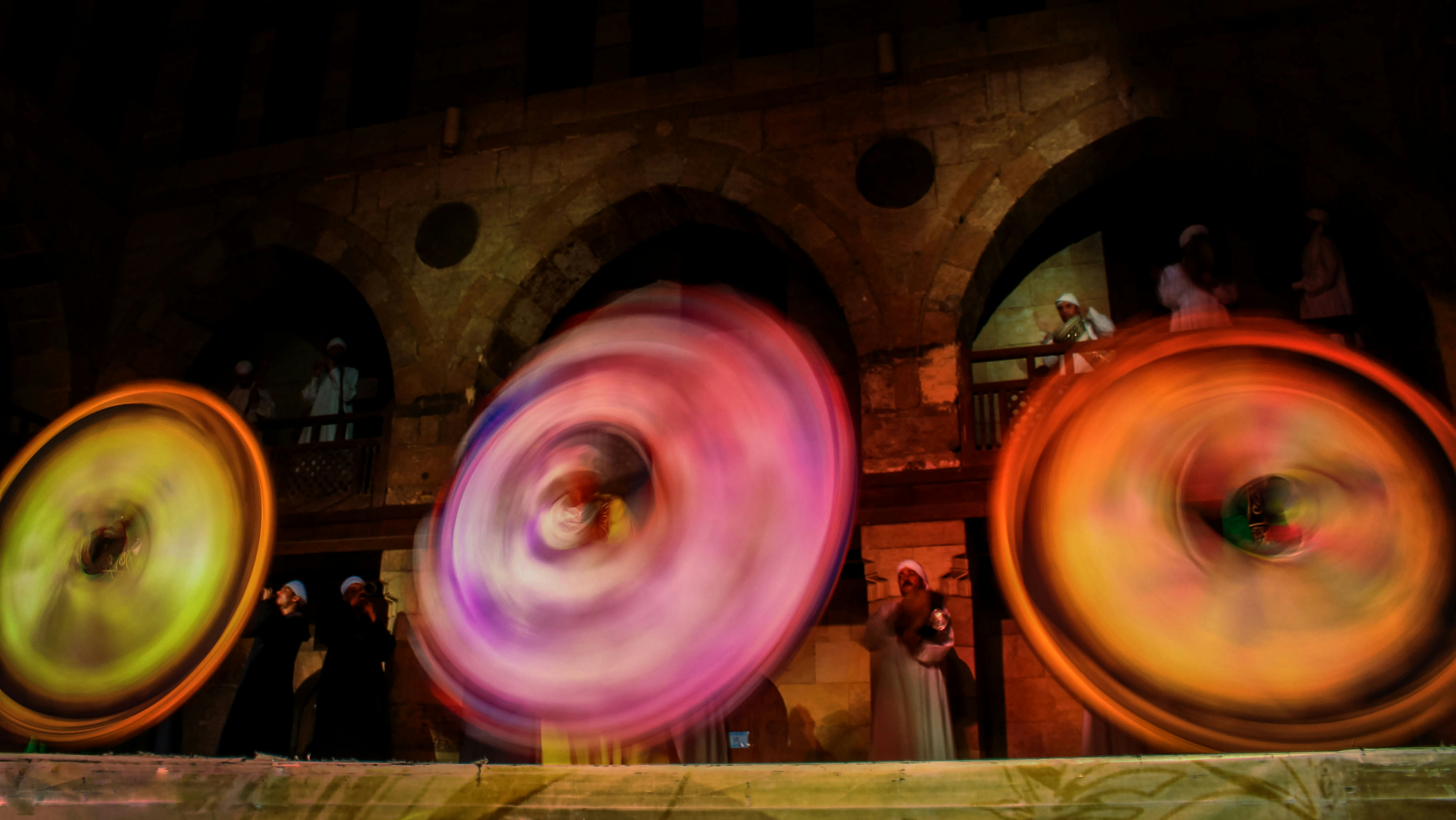 Three colorful spinning wheels in motion