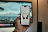 Hand holding smartphone displaying website with drinks.