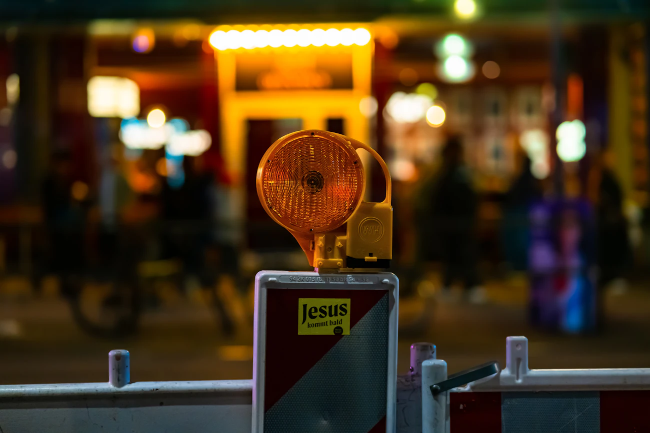 Flashing orange warning light on a barrier at night