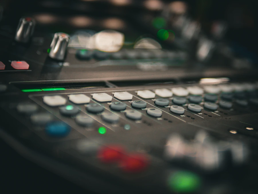 Professional audio mixing board with rows of controls