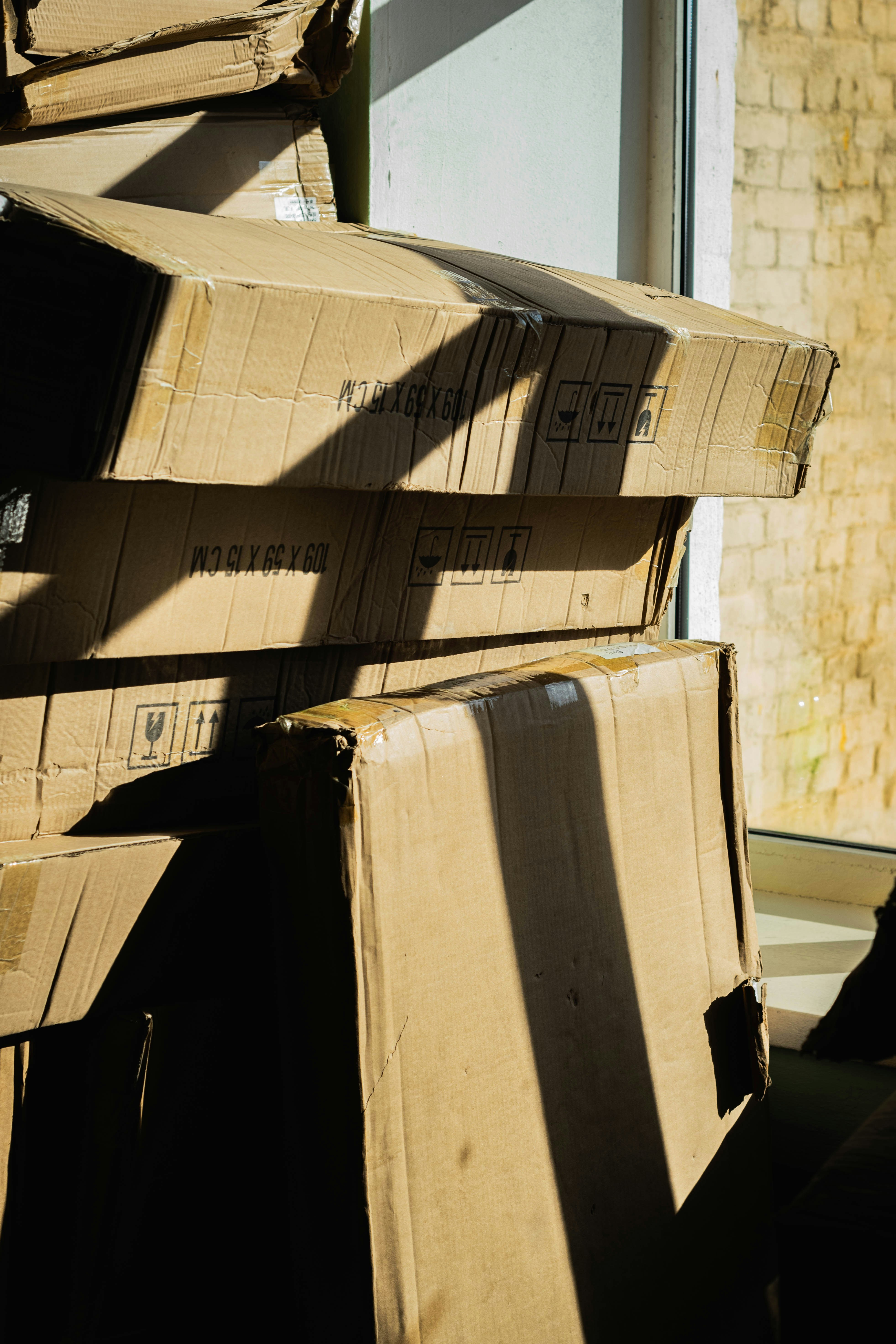 Stack of cardboard boxes near a window