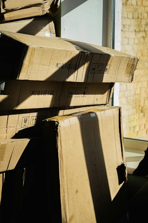 A stack of moving boxes near a window, as Las Vegas renters weigh signing a new lease with a concession or moving into a home they own