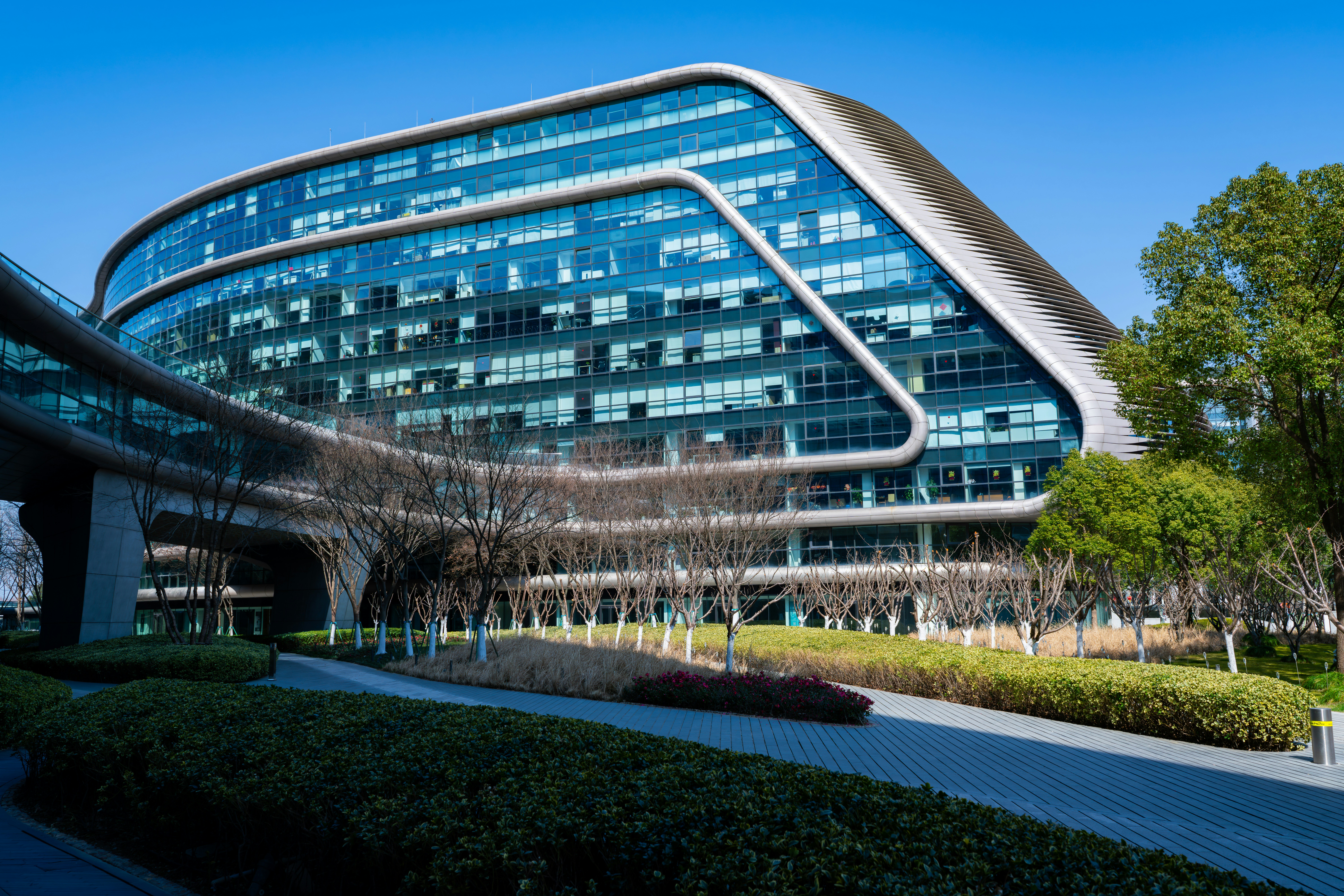 Modern glass building with curved architecture and angular architecture.
