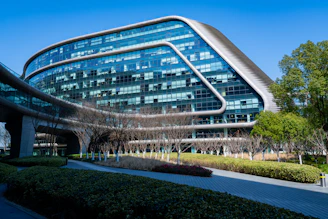 Modern glass building with curved architecture and angular architecture.