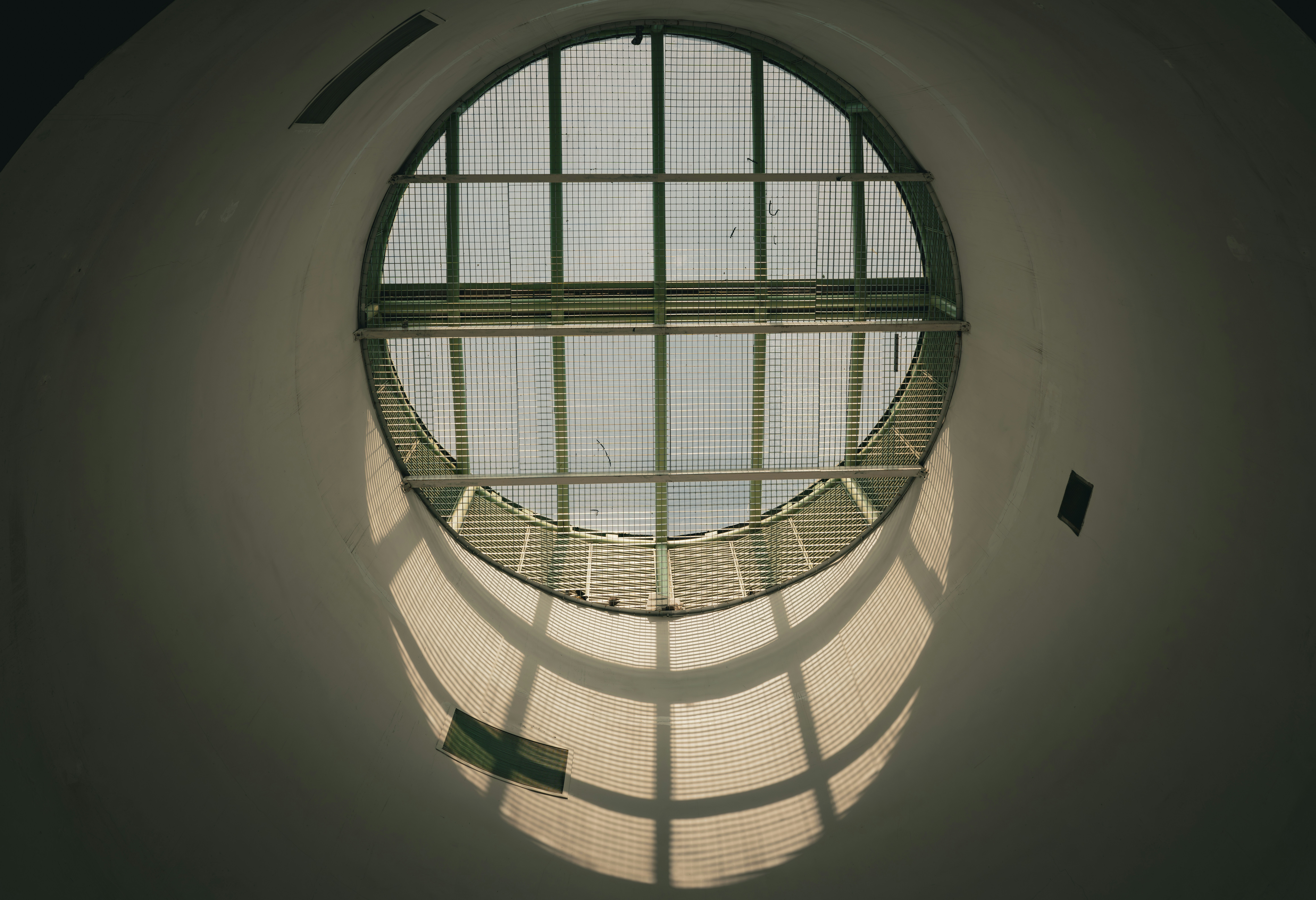Round window with sunlight casting a grid shadow - 相关推荐