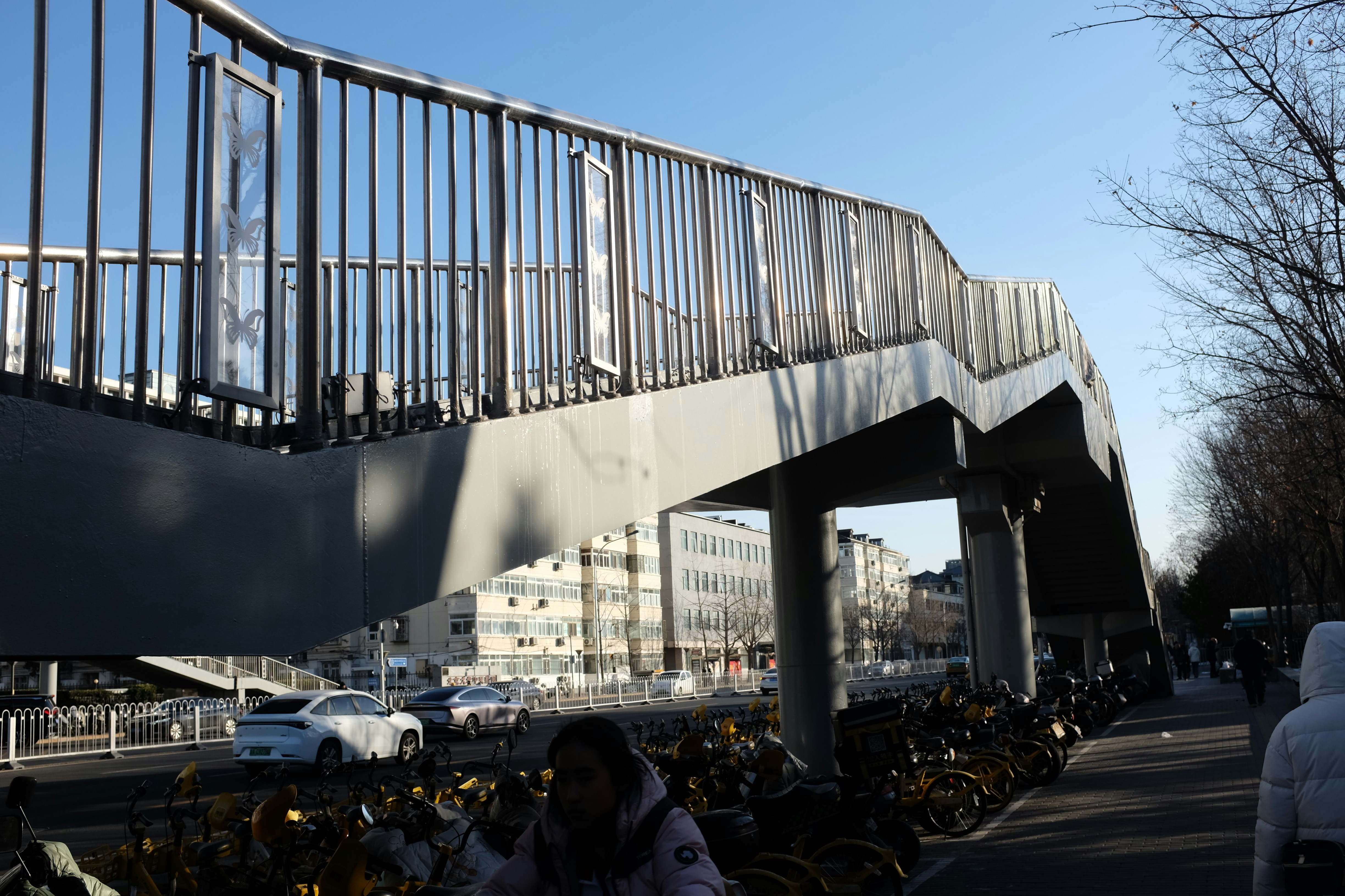 A modern pedestrian overpass above a busy street.