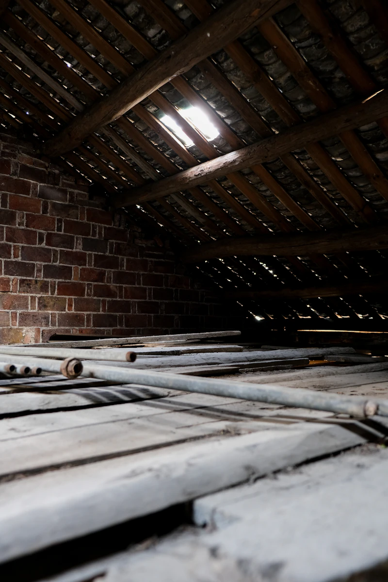 Technician working on HVAC ductwork inside a villa roof void