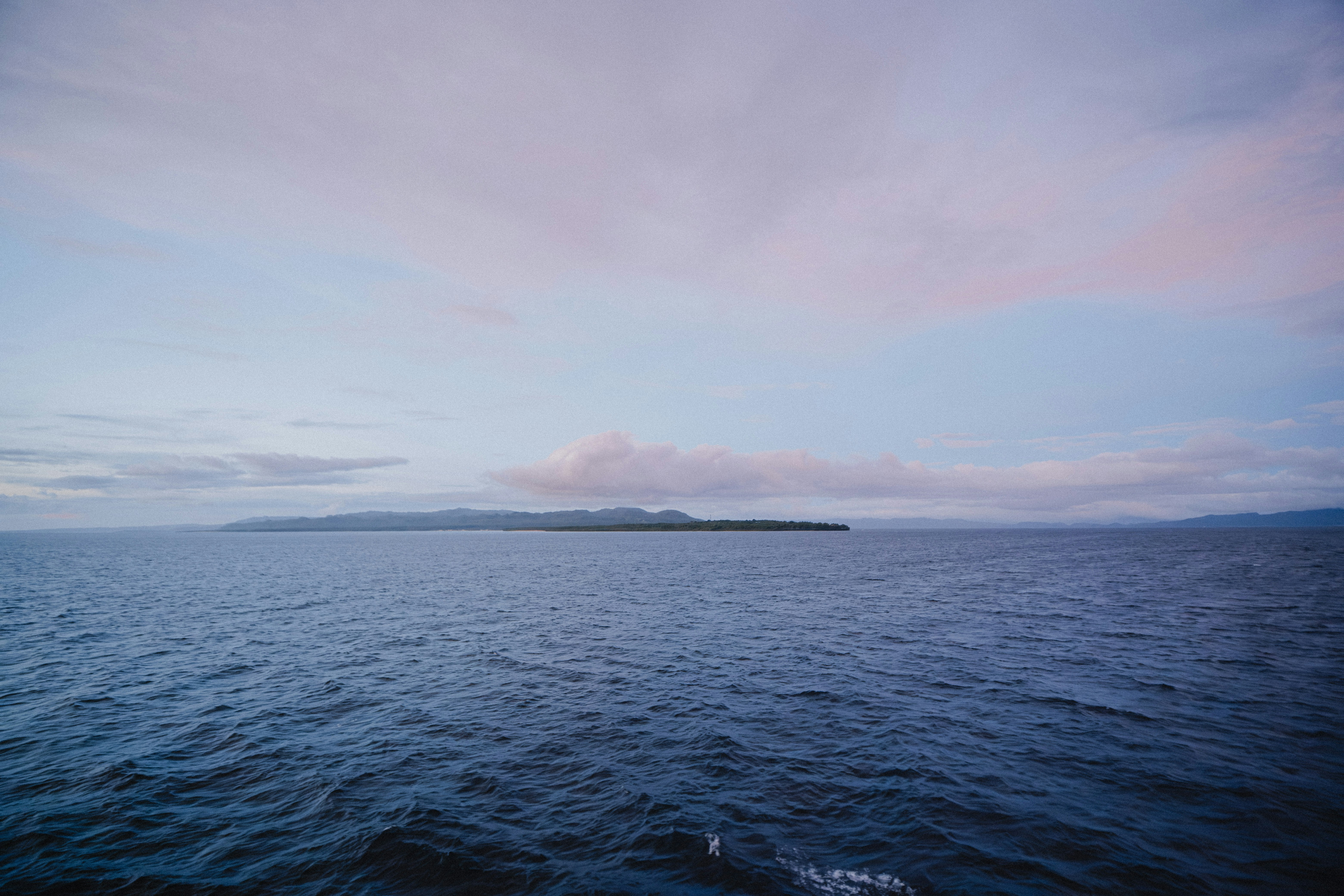 Isla lejana en el océano al amanecer