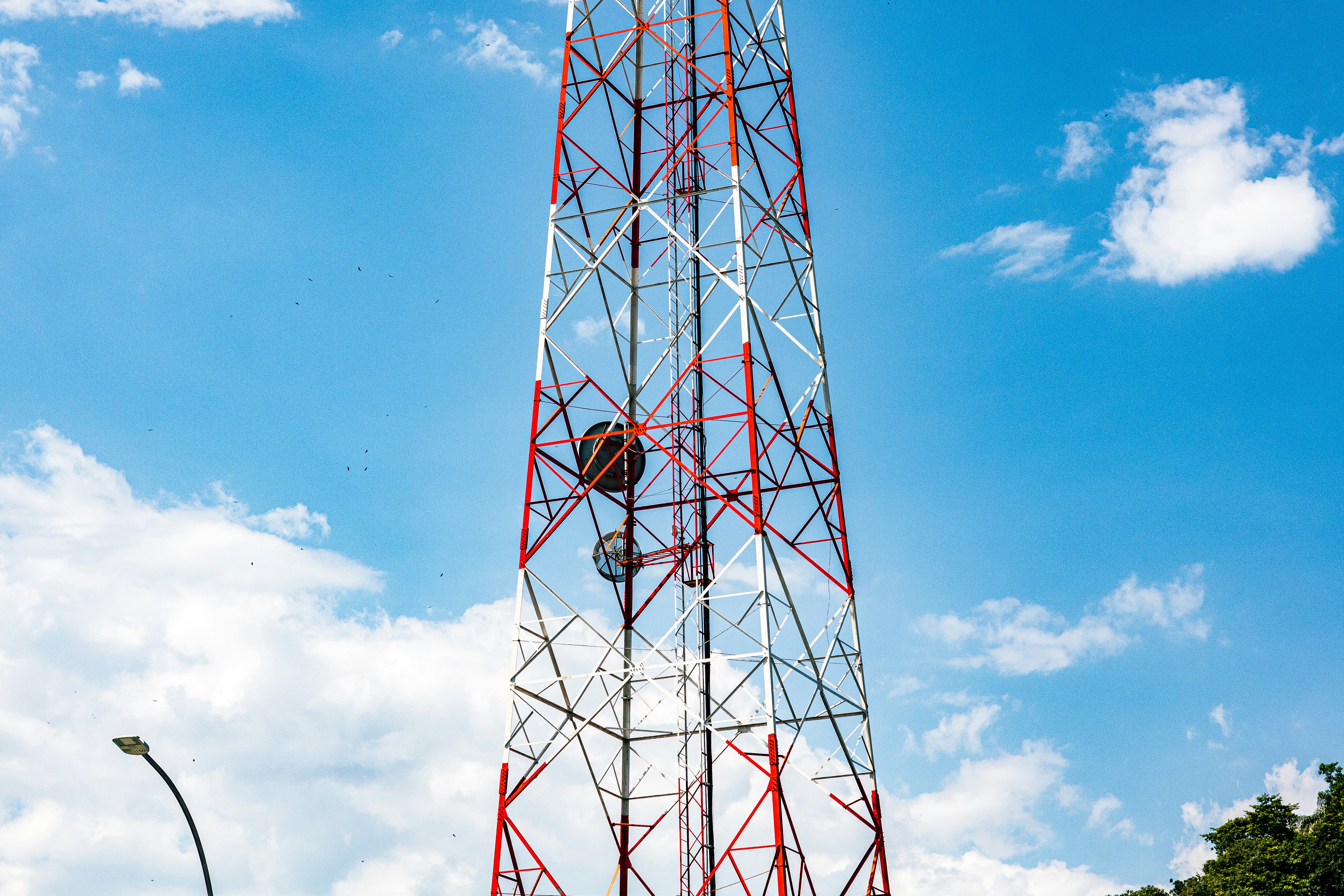 A tall telecommunications tower against a blue sky.