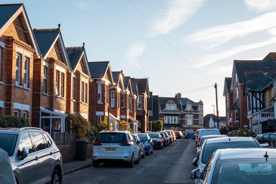 Row of parked cars on a residential street.