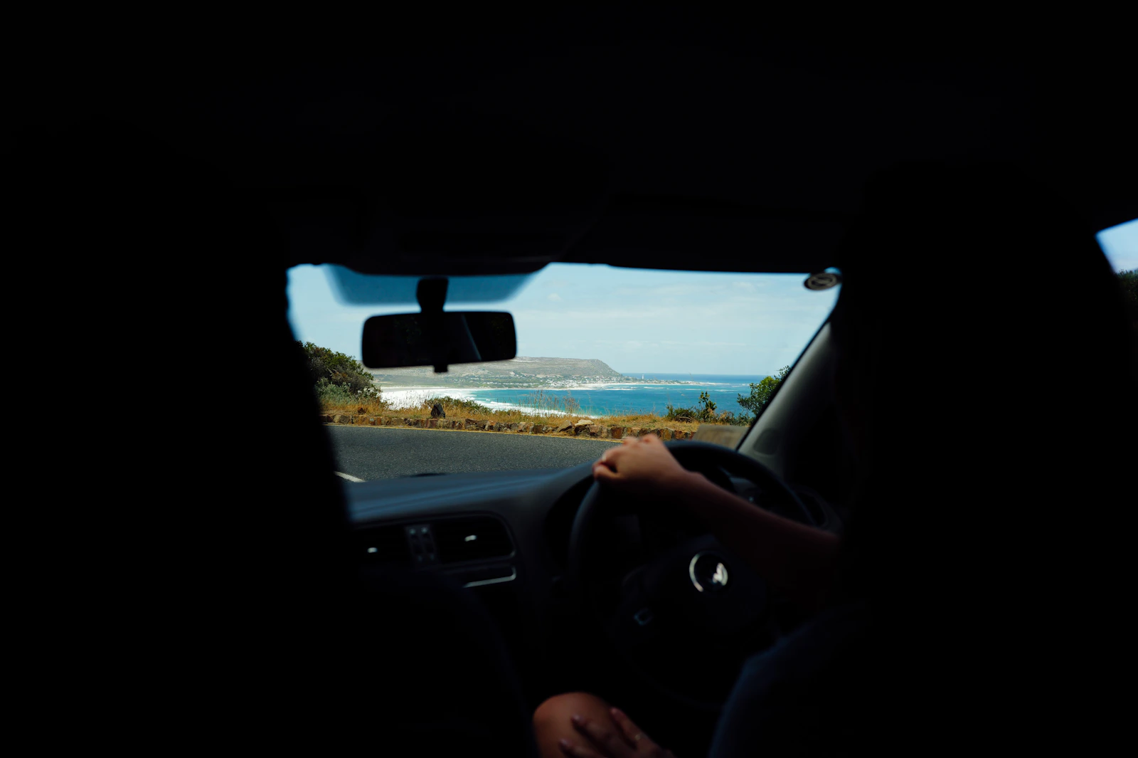 Scenic coastal road representing the journey home