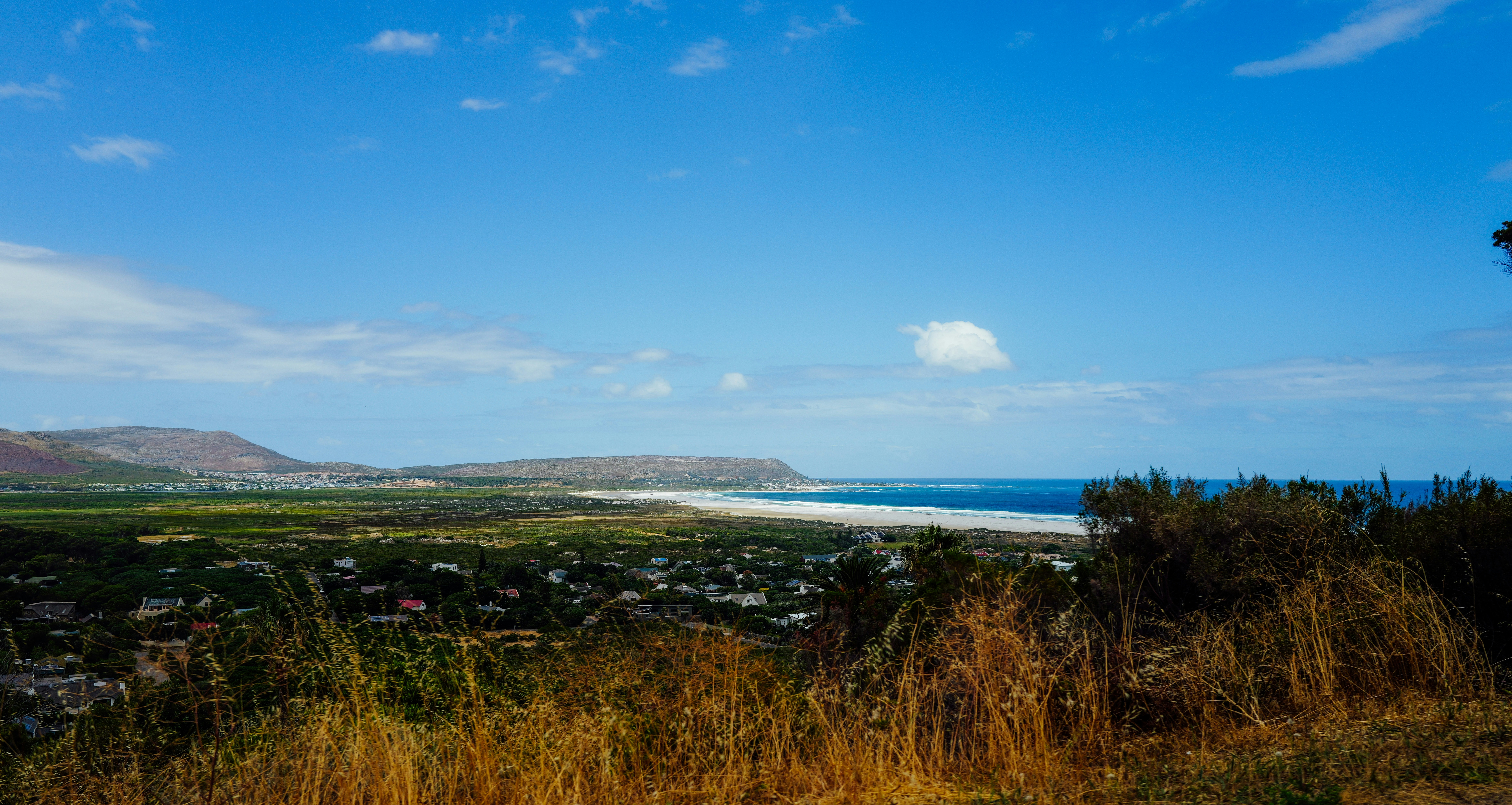 Coastal town with ocean view under blue sky