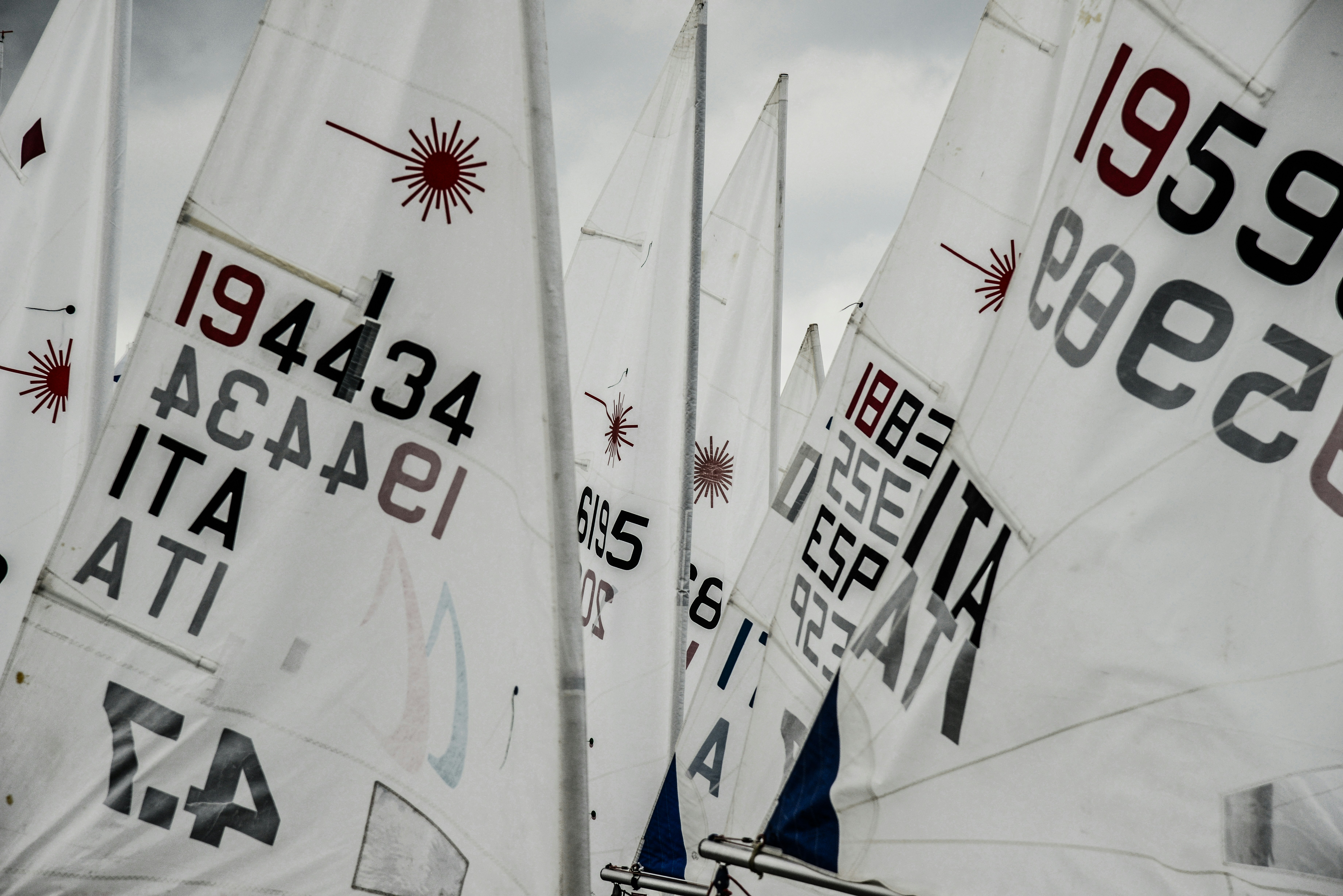 White sailboat sails with numbers and logos