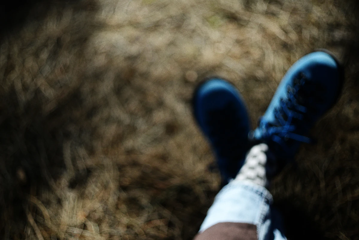 Blue shoes on dry grass