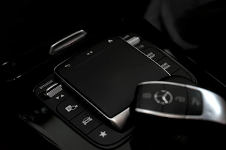 Close-up of a car's modern infotainment system controls.