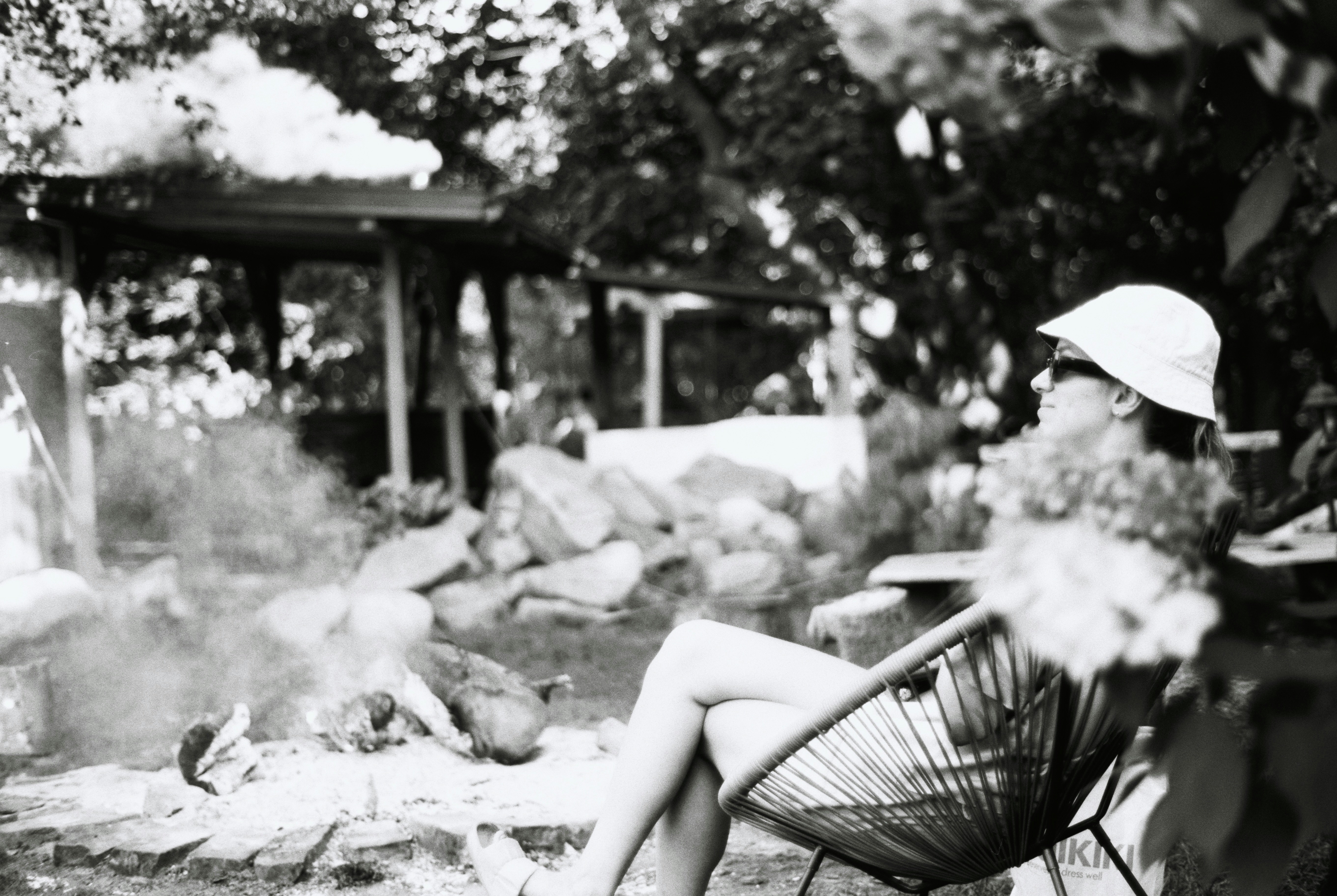 Woman in hat relaxing outdoors by a fire