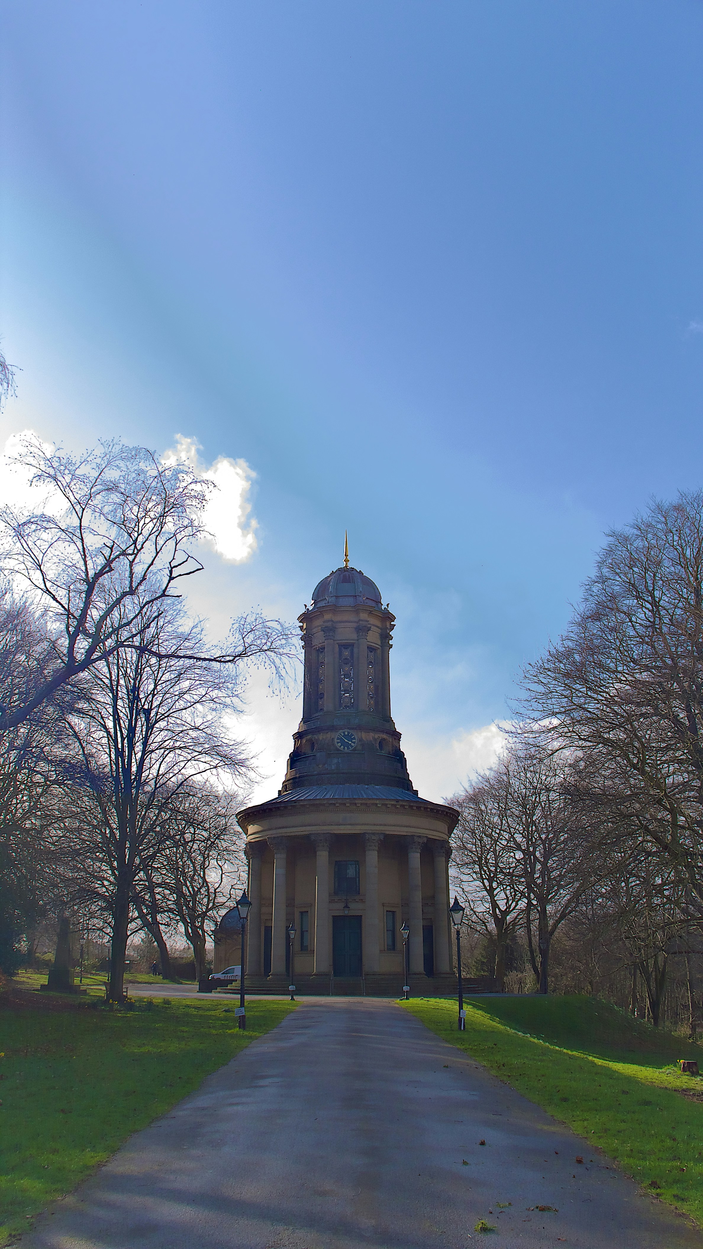 Neoclassical building with a dome surrounded by trees.