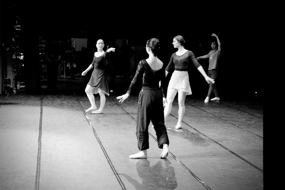 Four dancers performing together on stage