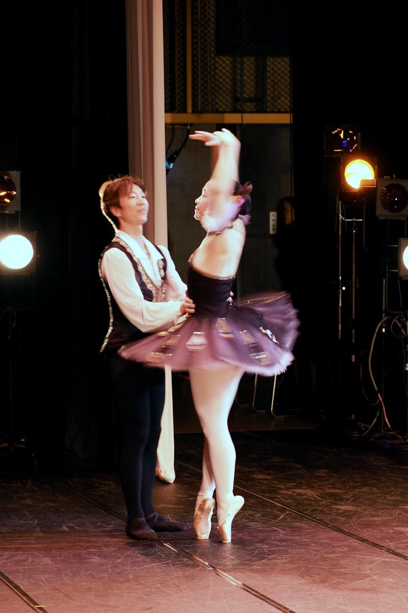 A dancer in a powerful pose with dramatic stage lighting