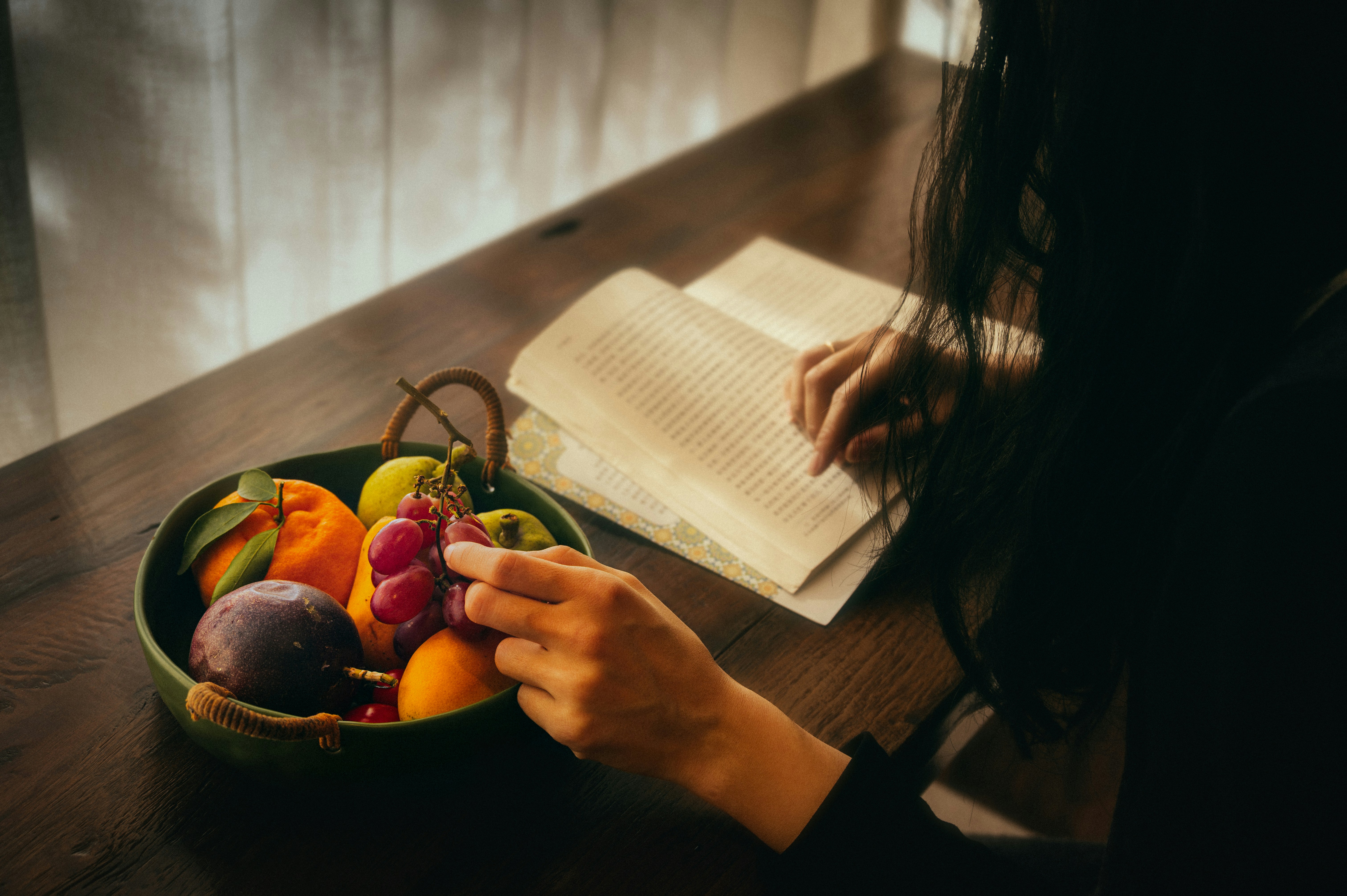 Person writing in a journal notebook in morning light