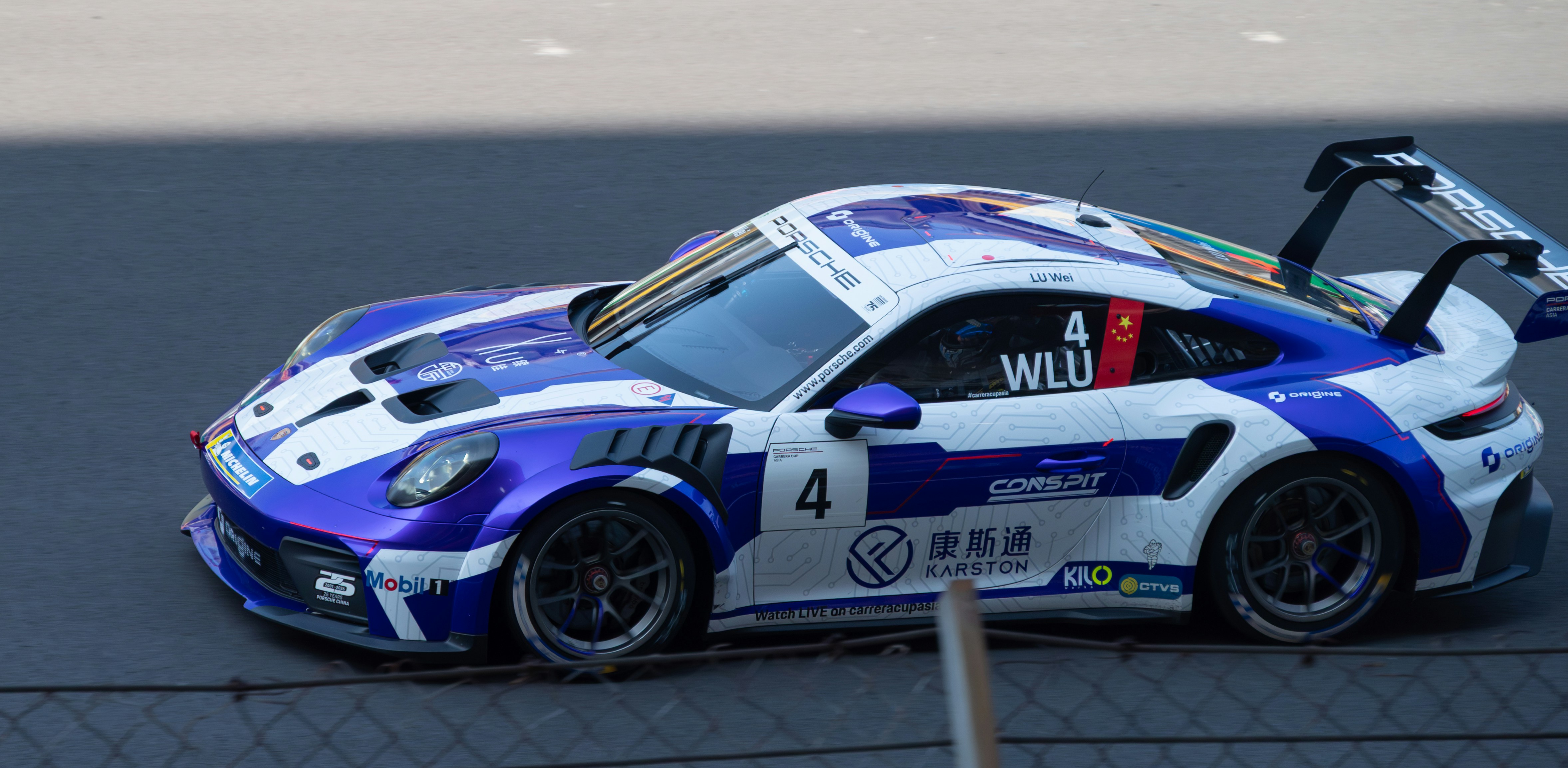 A blue and white race car on a track
