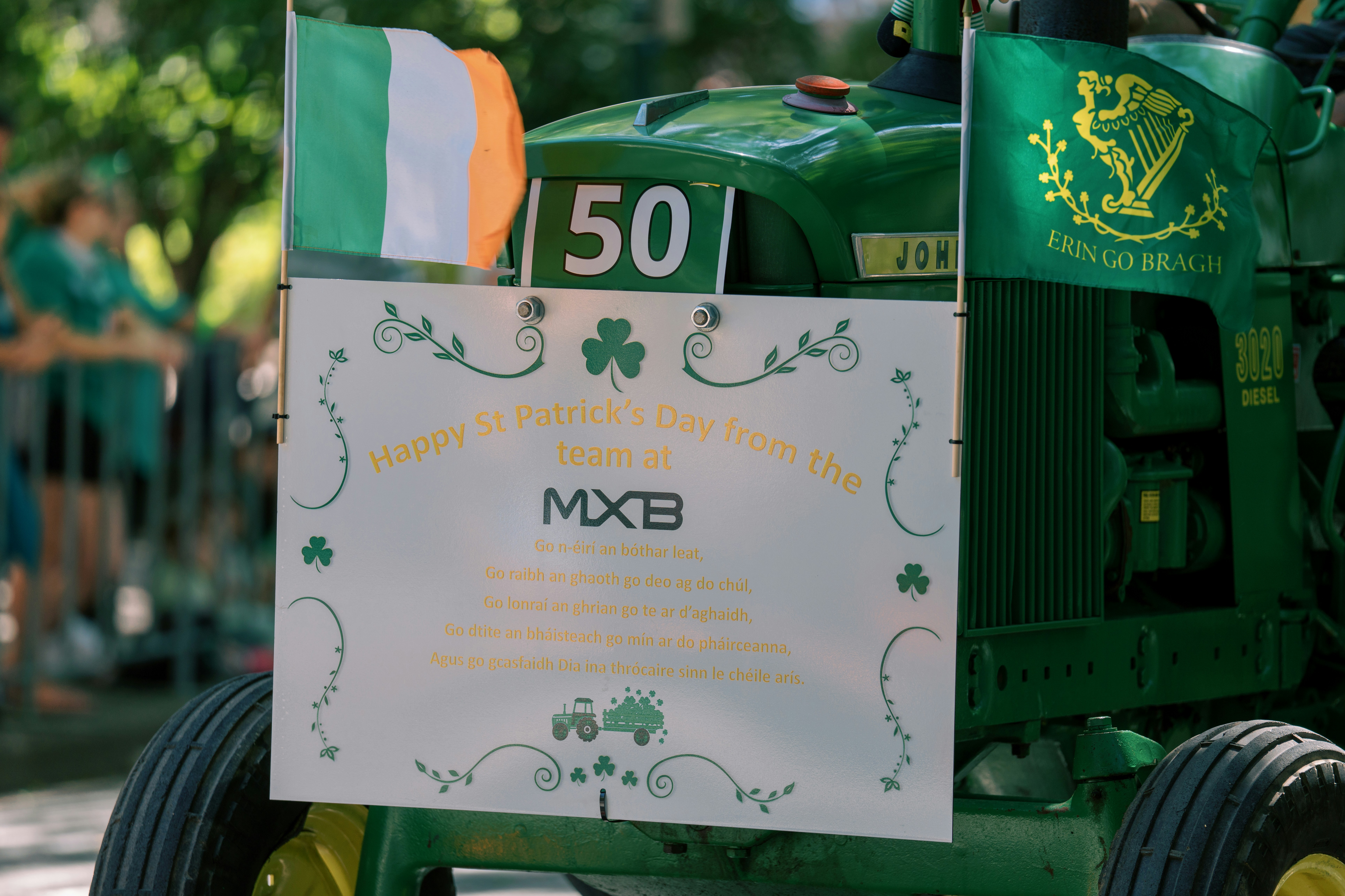 Grüner Traktor mit irischer Flagge und Kleeblättern