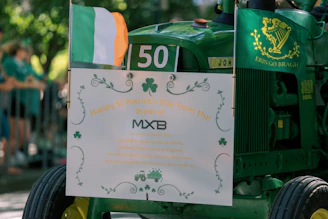 Green tractor with irish flag and shamrocks